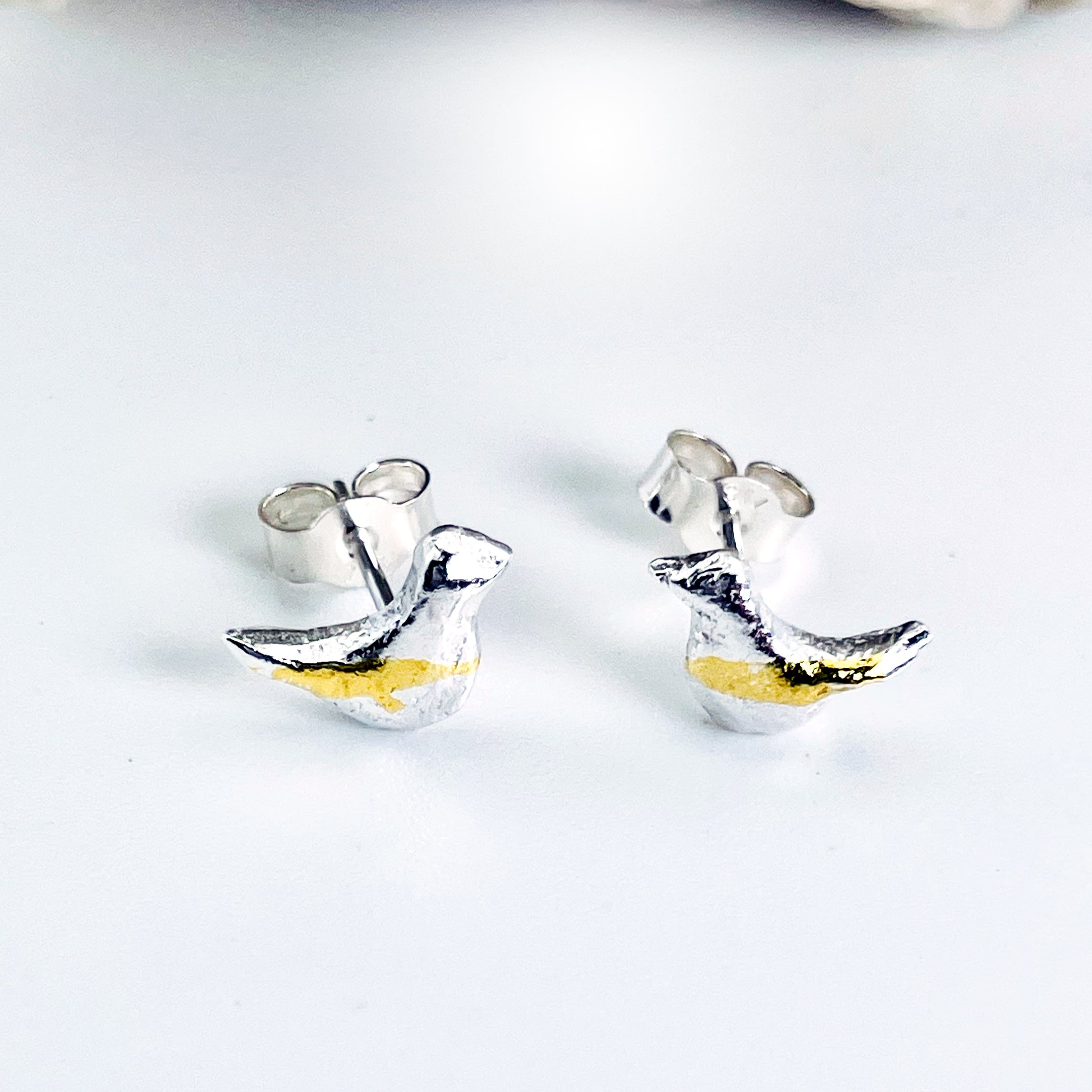 The Moorland Bird Studs are handcrafted in recycled fine silver and recycled 24ct gold accents with recycled sterling silver ear pins and scrolls, each bird is unique. Simple and elegant with a hammered finish, they can be worn everyday for any occasion.