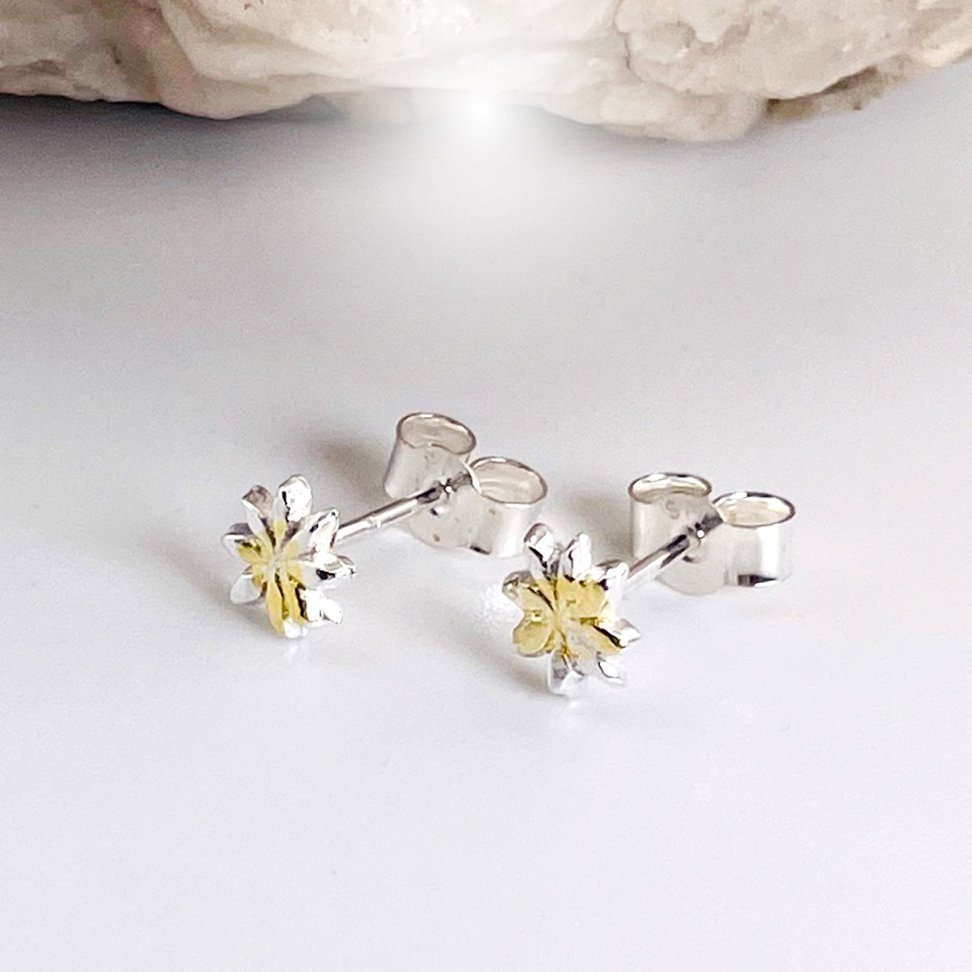 The Dartmoor Daisy Studs are inspired by the sea of daisies that speckle meadows of the lowland moor and waysides, bringing lightness and joy to the walker.