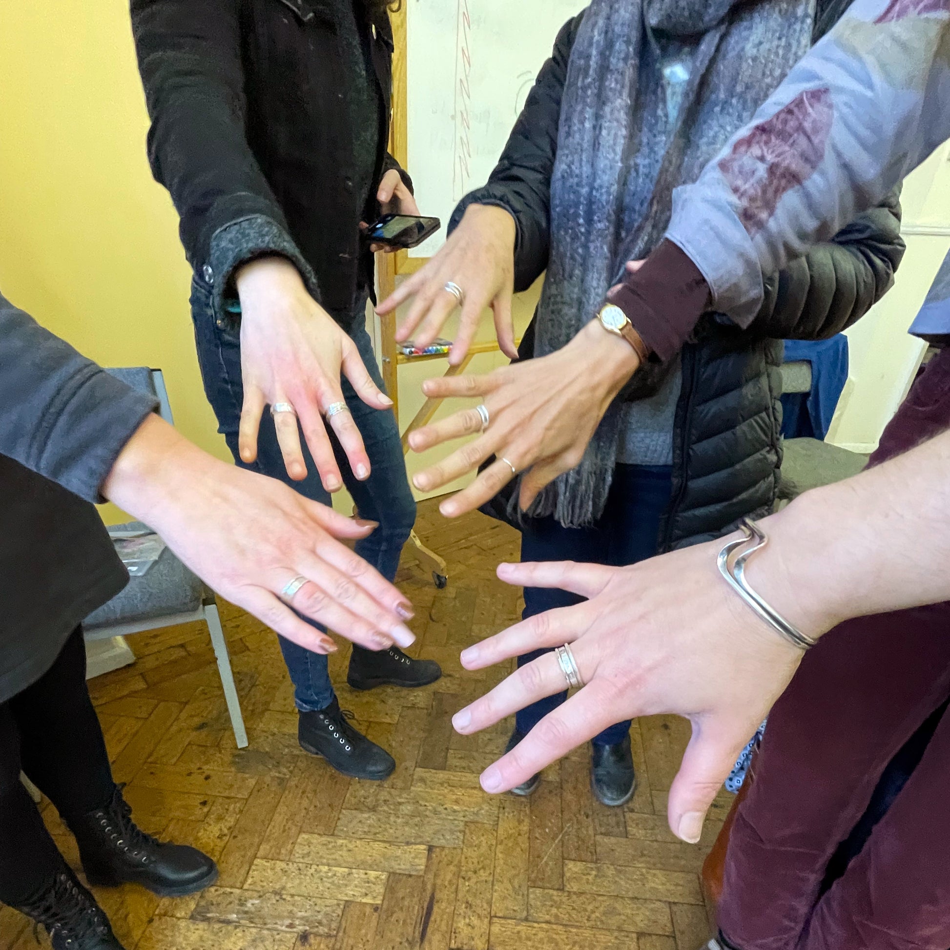 6 December 2025 Ashburton Jewellery School - Make Three Sterling Silver Stacking Rings- Group of people showing their hands with rings they have made in the workshop