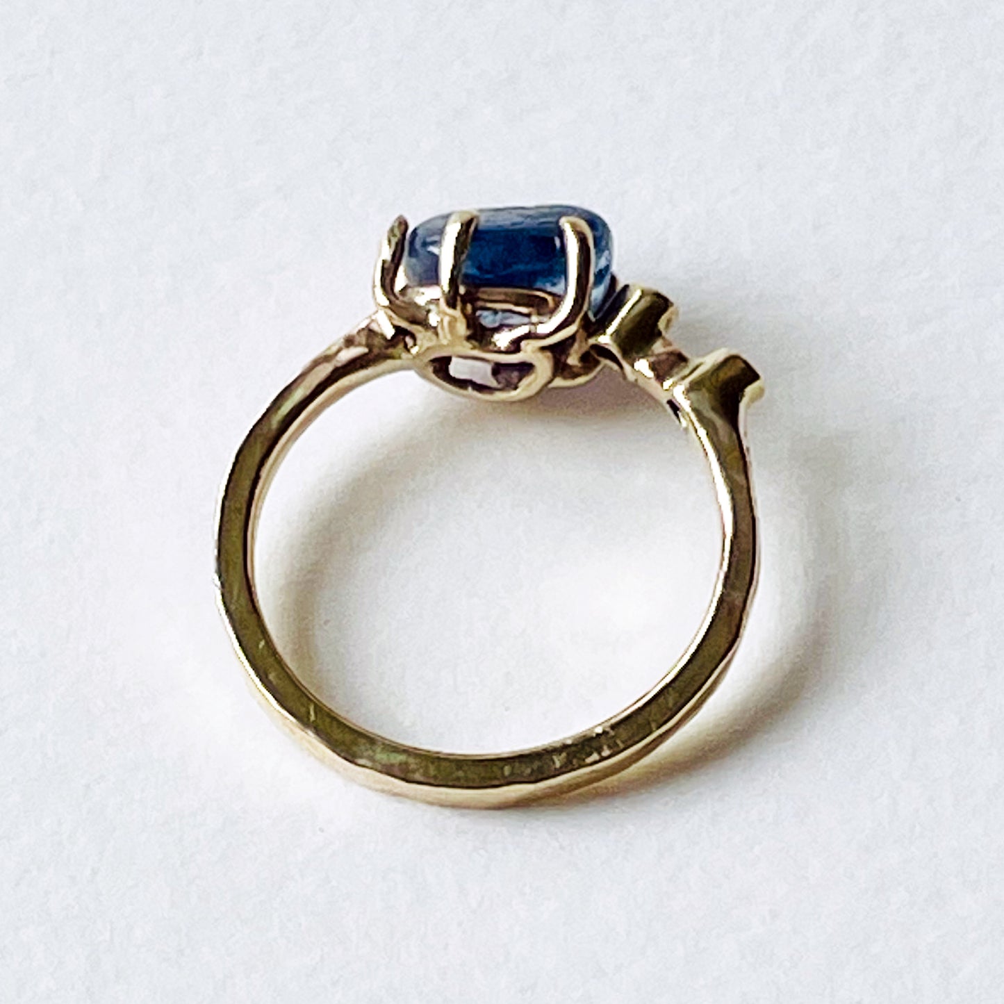 Side view - the Dartmoor Sun and Skies Sapphire Ring reflects the big Dartmoor skies, the contrasting colours and textures of the moving light over the landscape, created with ethically sourced raw and facetted sapphires and different shades of gold.