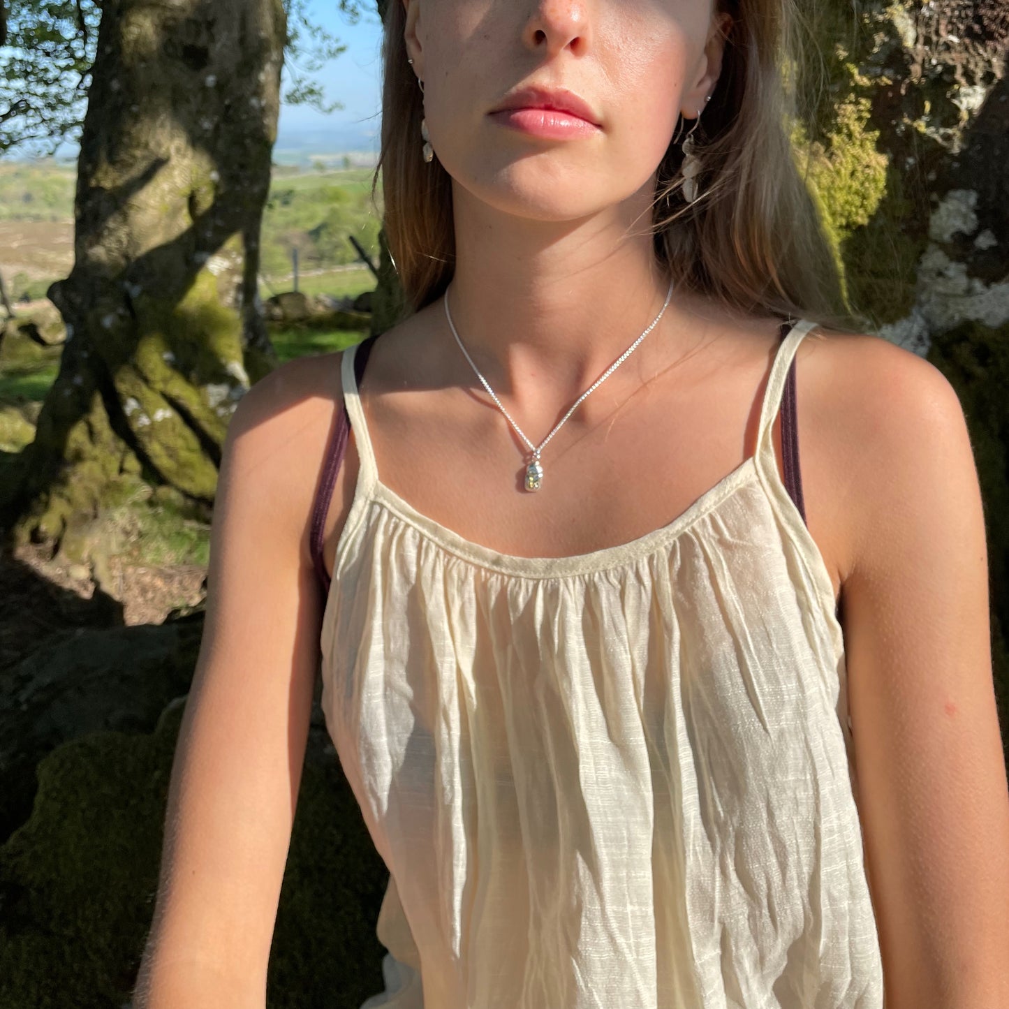 The Expanded Skies Dartmoor Scarab Pendant Necklace is inspired by the Dumbledore or Dor beetle, recycled fine silver with 24ct gold accents, worn on Dartmoor.
