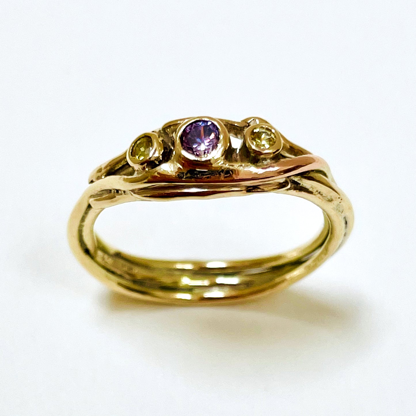 The Haytor Heather and Gorse Ring evokes the beautiful yellows of the gorse and purples of the heather with ethically sourced yellow sapphires and a purple spinel held in three twisting branches of 9ct yellow with accents of 9ct rose gold . This totally handcrafted piece makes a wonderful gift, engagement ring or perfect encapsulation of joy.