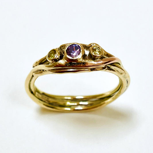 The Haytor Heather and Gorse Ring evokes the beautiful yellows of the gorse and purples of the heather with ethically sourced yellow sapphires and a purple spinel held in three twisting  branches of 9ct yellow with accents of 9ct rose gold . This totally handcrafted piece makes a wonderful gift, engagement ring or perfect encapsulation of joy.