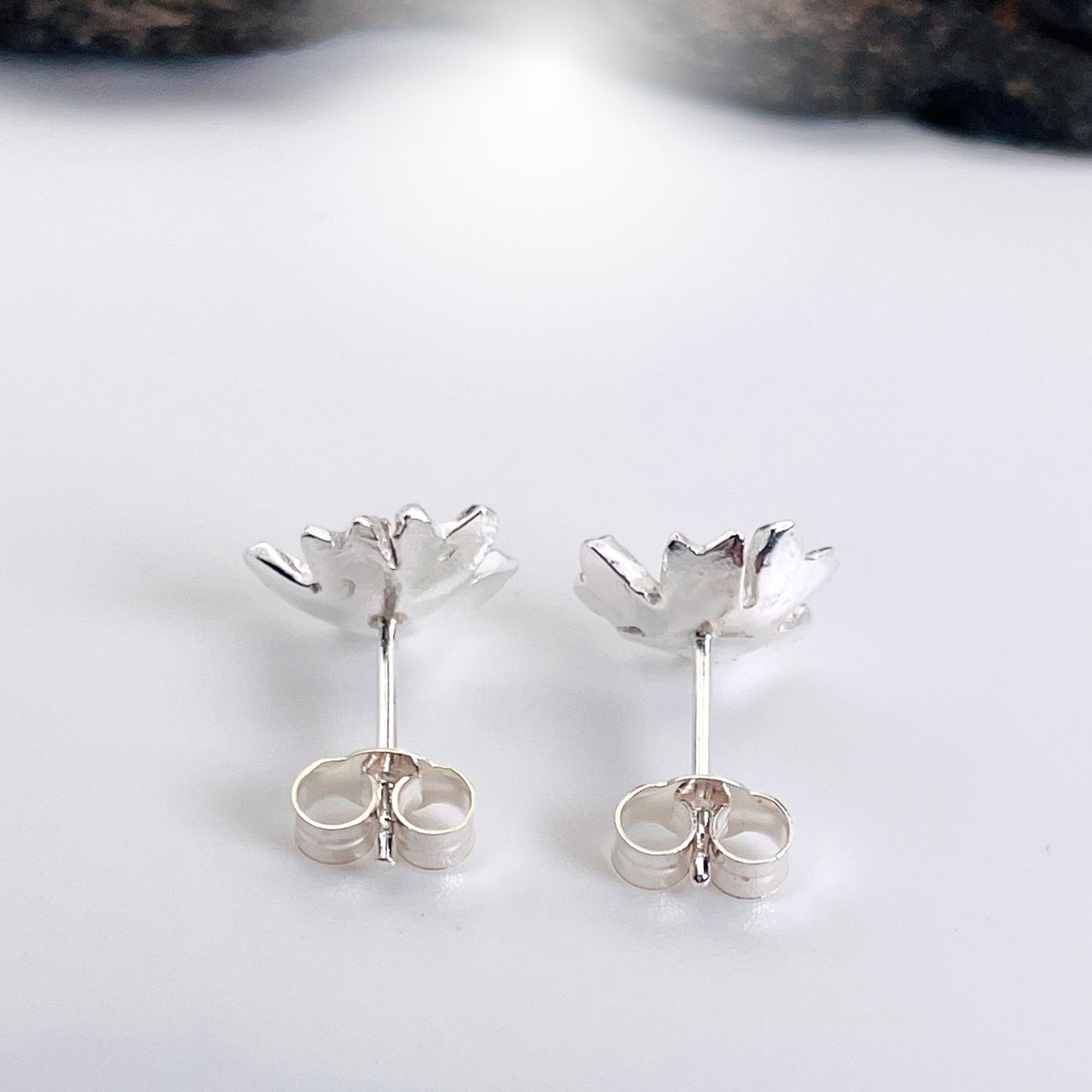 The Expanded Skies Dartmoor Field Rose Studs captures the joyous simple beauty of the field rose, Rosa arvensis, that is seen weaving brightly through the Dartmoor hedgerows and woodland.
Handcrafted in recycled fine silver with recycled 24ct gold accents and recycled sterling silver ear pins and scrolls.