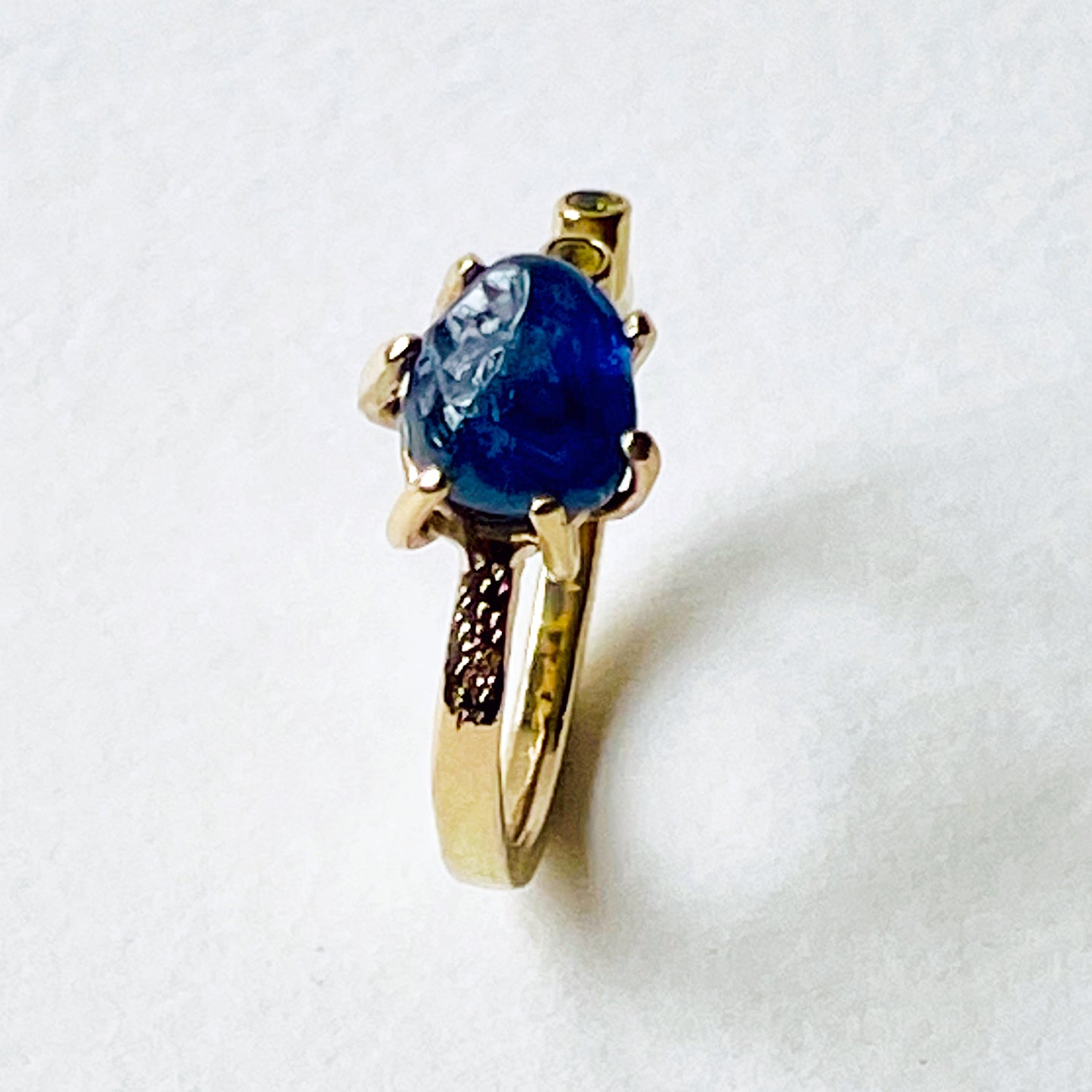 Top view engraving- the Dartmoor Sun and Skies Sapphire Ring reflects the big Dartmoor skies, the contrasting colours and textures of the moving light over the landscape, created with ethically sourced raw and facetted sapphires and different shades of gold.