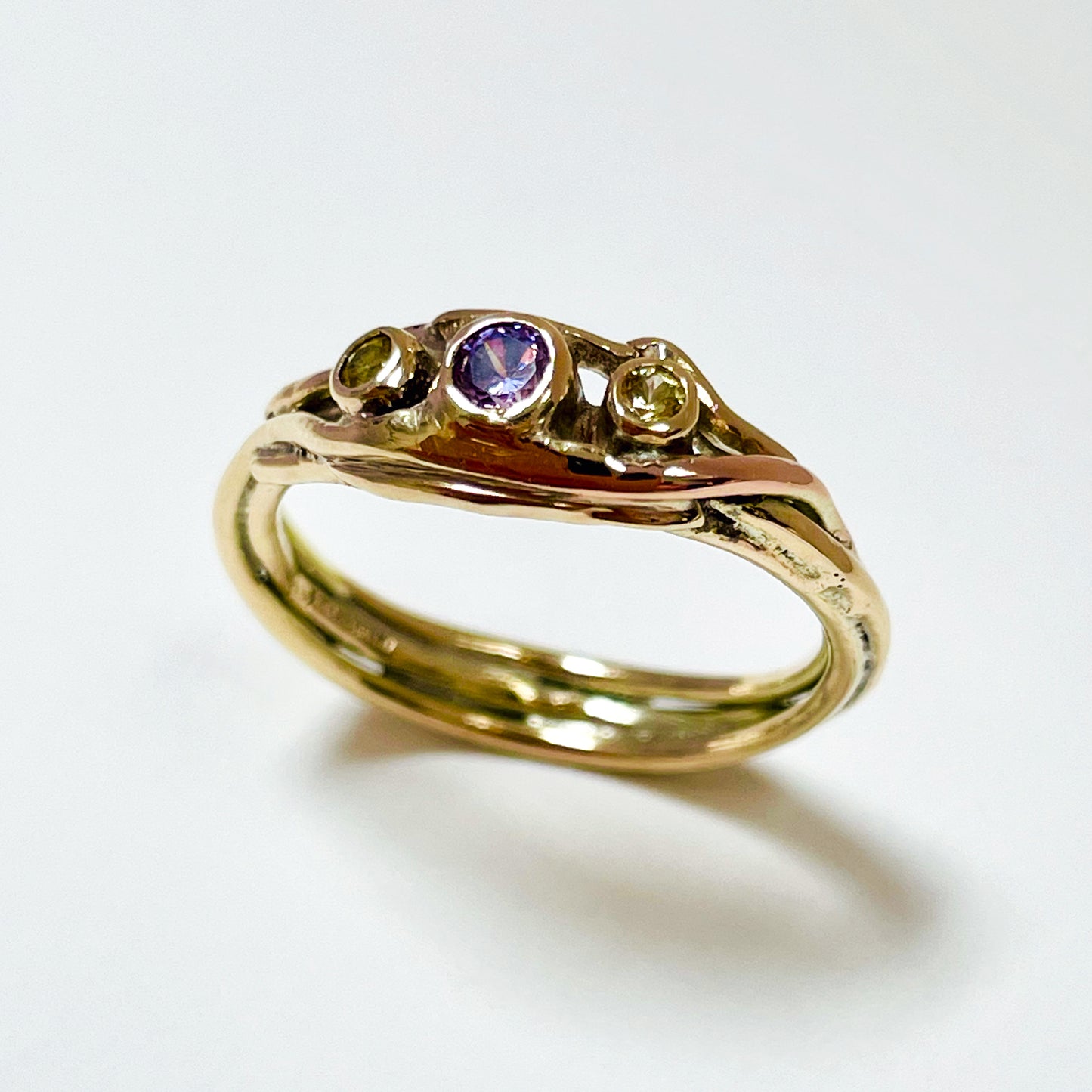 The Haytor Heather and Gorse Ring evokes the beautiful yellows of the gorse and purples of the heather with ethically sourced yellow sapphires and a purple spinel held in three twisting branches of 9ct yellow with accents of 9ct rose gold . This totally handcrafted piece makes a wonderful gift, engagement ring or perfect encapsulation of joy.