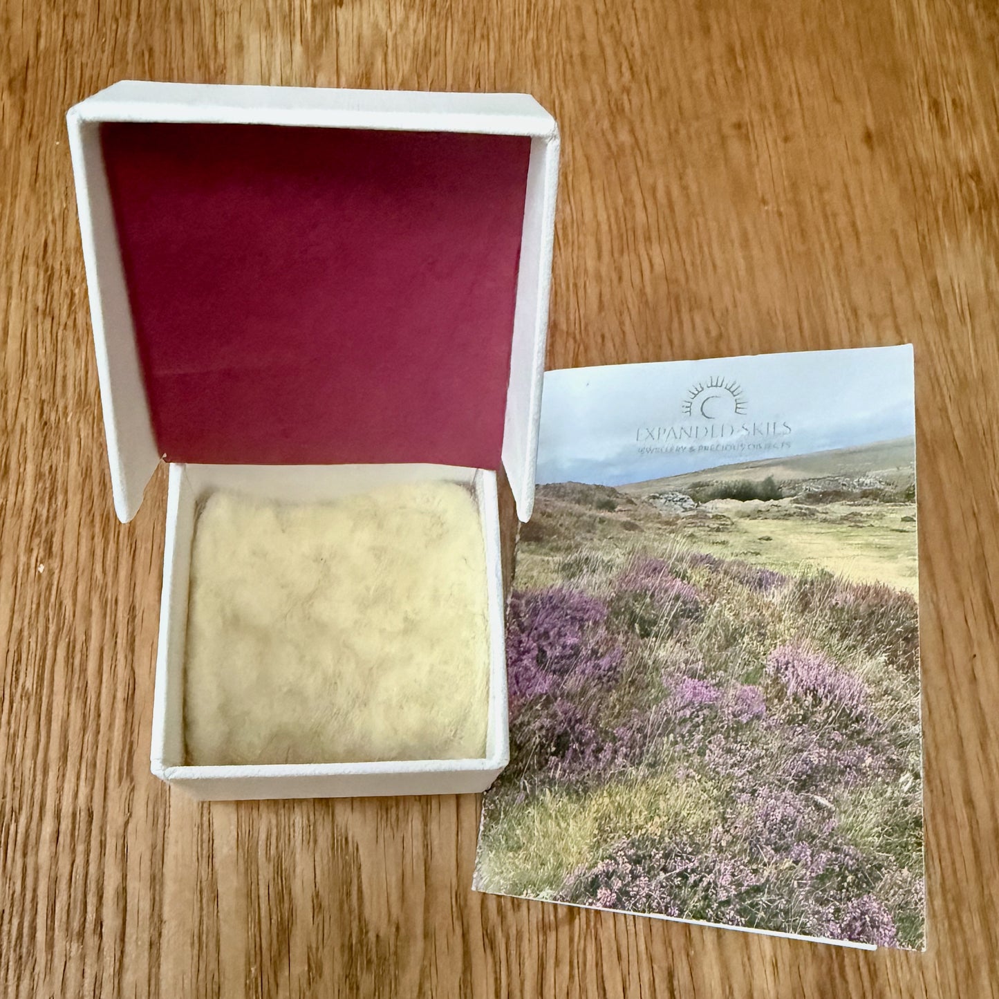 Expanded Skies packaging, a beautiful presentation box, handcrafted in Cornwall with recycled board and textured paper. The interior of the box is lined with natural felt from organically reared sheep from Fernhill Farm in Somerset and berry tissue made from recycled fibres. The box comes with a card featuring a photograph of Dartmoor taken by Emma and accompanying details of the brooch, printed on FSC certified paper. The packaging is 100% recyclable.