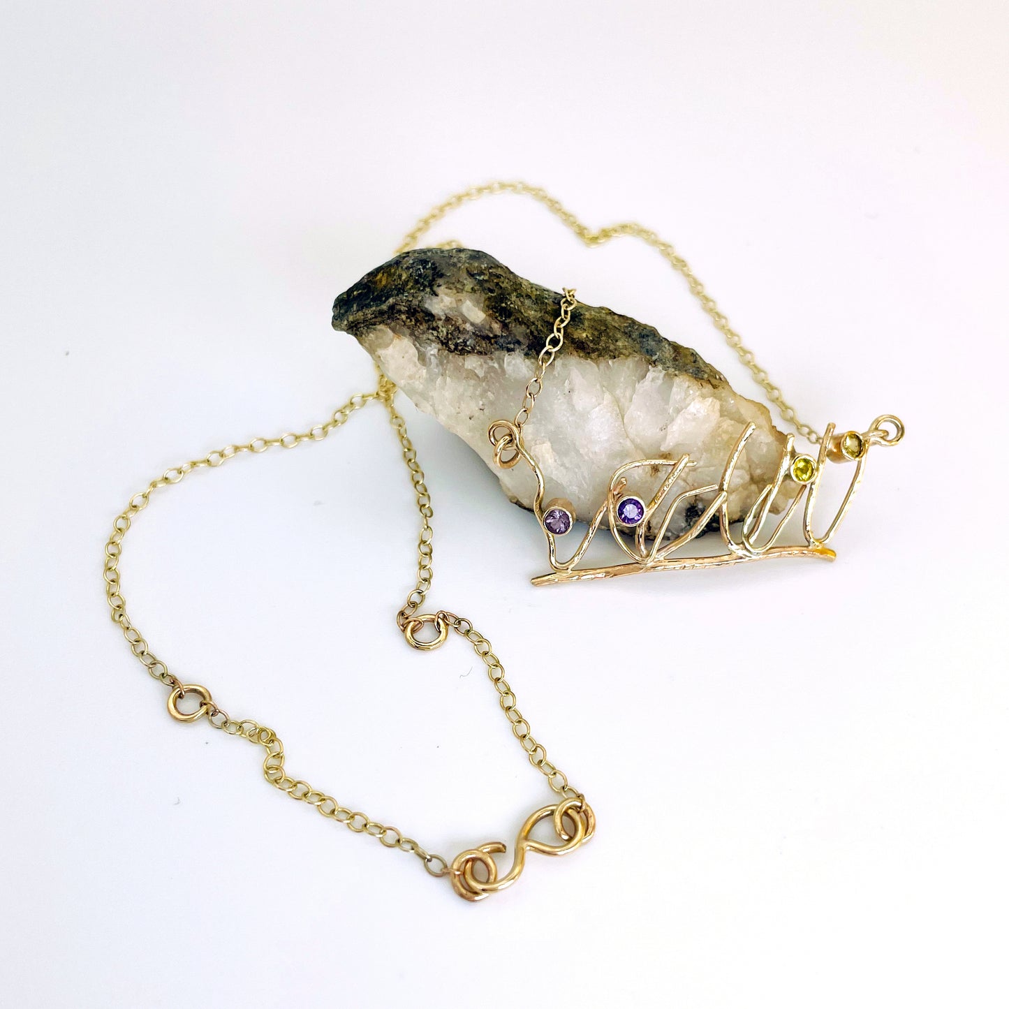 The Expanded Skies Dartmoor Heather and Gorse Necklace evokes the beautiful yellows of the gorse and purples of the heather with two ethically sourced yellow sapphires and two amethysts from Nineteen48 Ltd held in twisting branches of 9ct yellow gold. The chain can be worn at two different lengths, the shorter with a back drop.
This handcrafted unique, one-off, piece makes a wonderful gift, celebrating the evocative and joyful colours of Dartmoor.