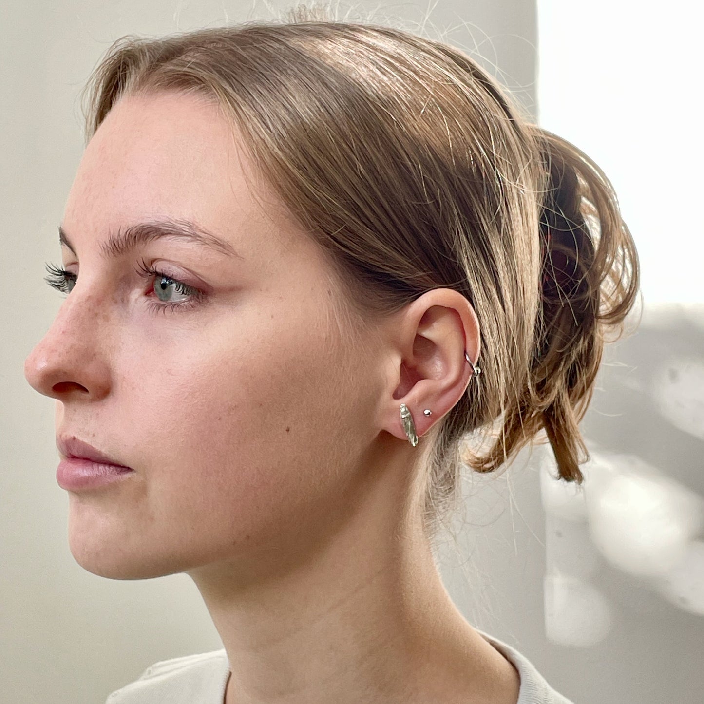 Inspired by the Dartmoor granite rocks abundant with large quartz crystals, megacrysts. The Dartmoor Megacryst Studs are handcrafted in recycled fine silver with recycled sterling silver ear pins and scrolls, each megacryst is unique. Simple and elegant with a textured finish, they can be worn everyday for any occasion.