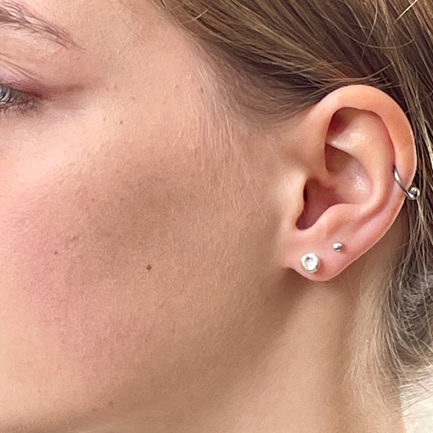 Inspired by the sculptural beauty of the Dartmoor granite rocks. The Dartmoor Rocks Studs are handcrafted in recycled fine silver with recycled sterling silver ear pins and scrolls, each stud is unique. Simple and elegant with a textured finish, and a polished finish they can be worn everyday for any occasion.