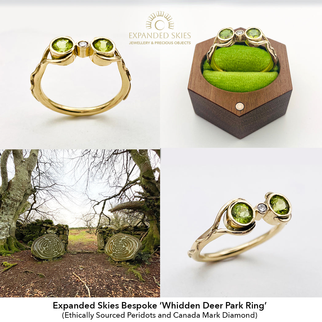 Bespoke 'Whidden Deer Park Ring' by Expanded Skies with green gemstones and gold band, displayed with packaging and natural setting.