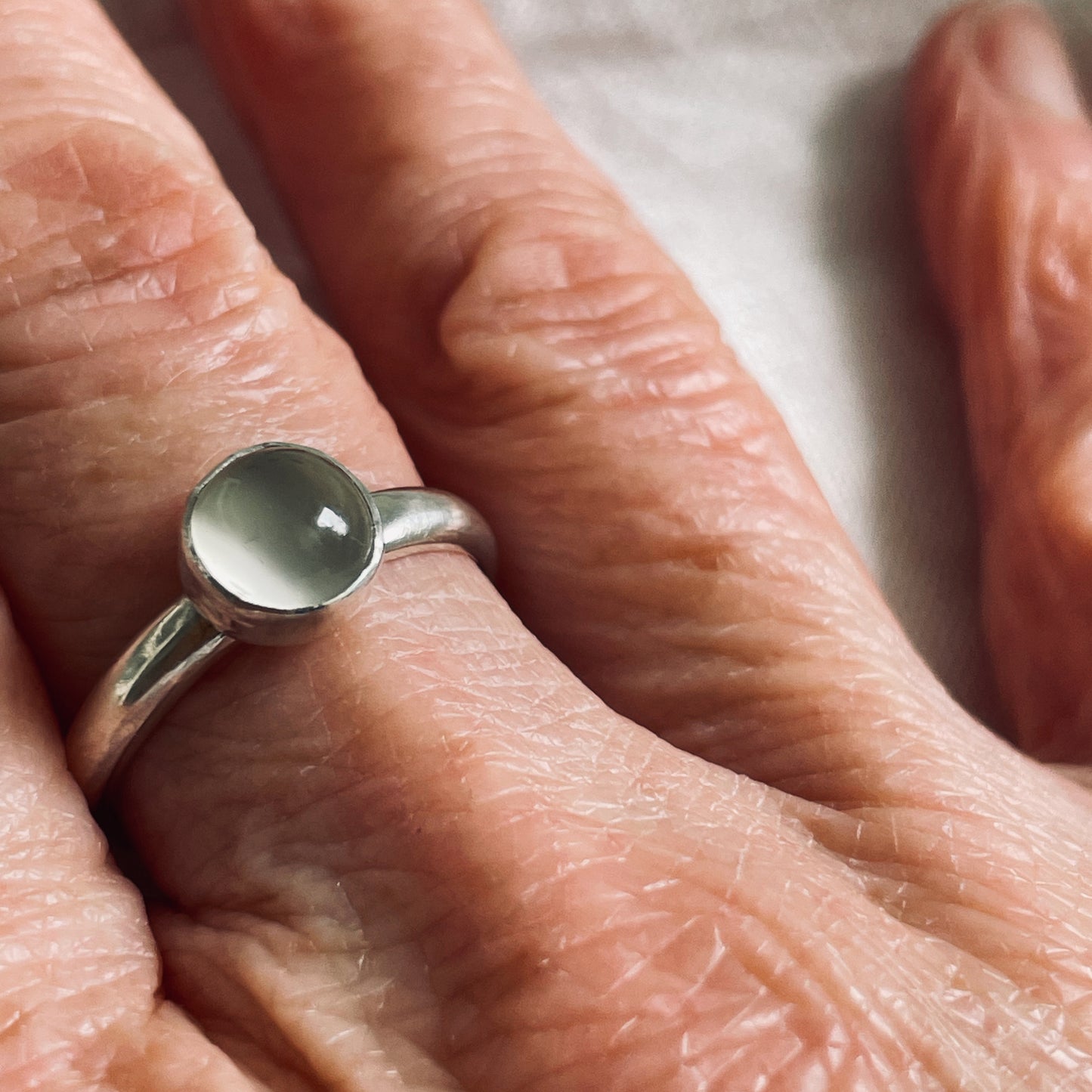 The Full Moon Moonstone Ring has a tranquil beauty of the light of the full moon reflected on a still pool. Totally handcrafted, it features an ethically mined moonstone from Sri Lanka set in quality 100% recycled sterling silver.