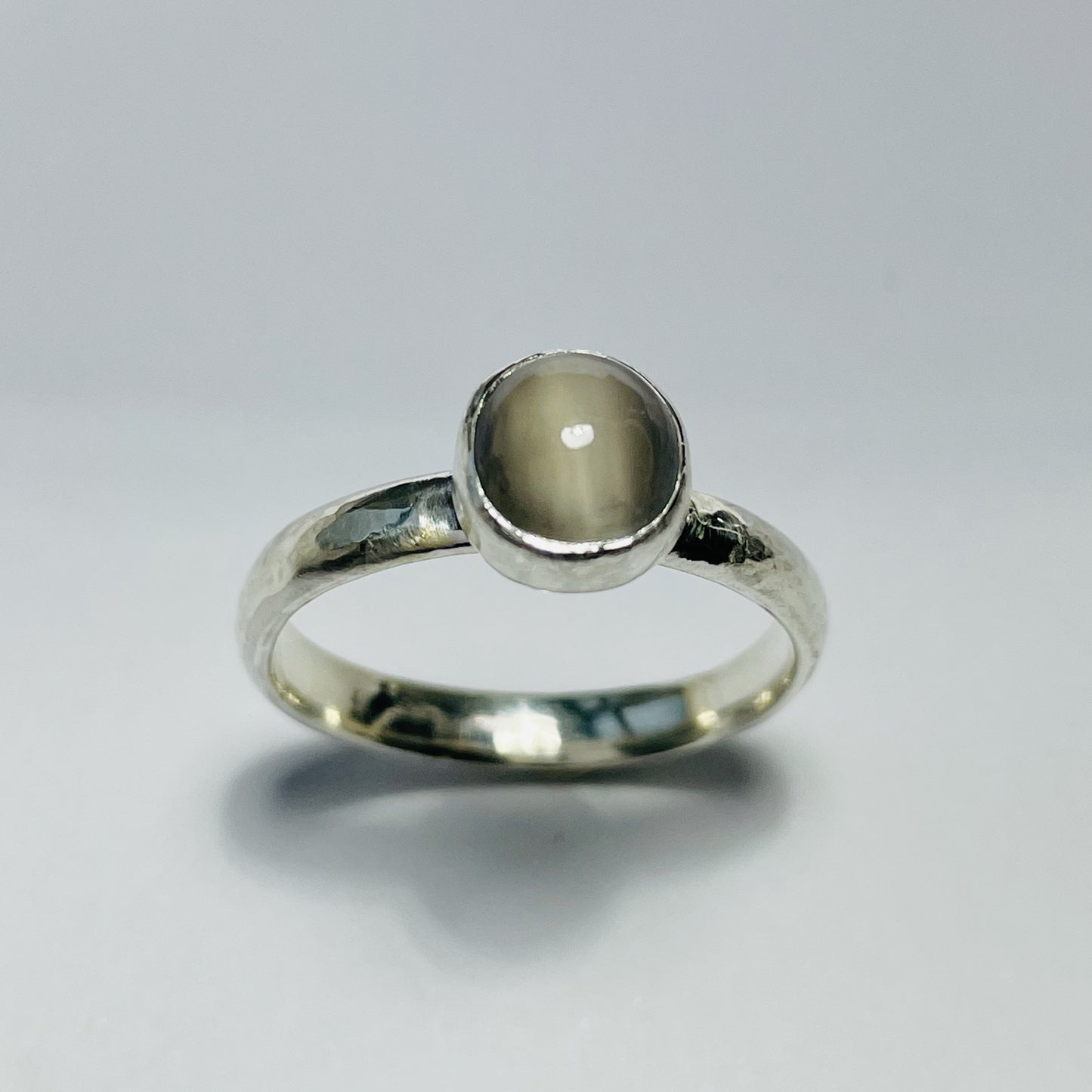 The Expanded Skies Full Moon Moonstone Ring has a tranquil beauty of the light of the full moon reflected on a still pool. Totally handcrafted, it features an ethically mined moonstone from Sri Lanka set in quality 100% recycled sterling silver with a hammered band. 