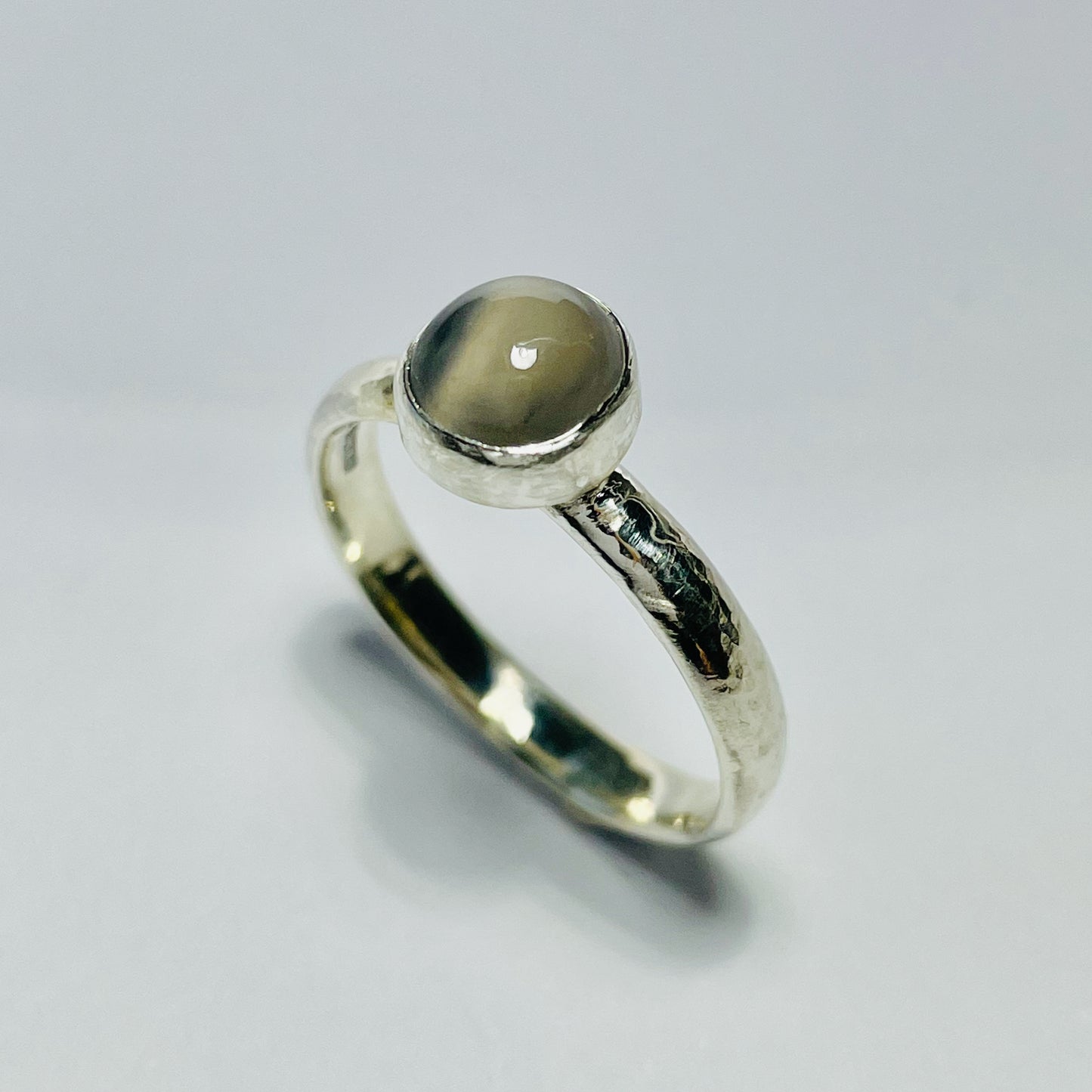 The Expanded Skies Full Moon Moonstone Ring has a tranquil beauty of the light of the full moon reflected on a still pool. Totally handcrafted, it features an ethically mined moonstone from Sri Lanka set in quality 100% recycled sterling silver with a hammered band. 