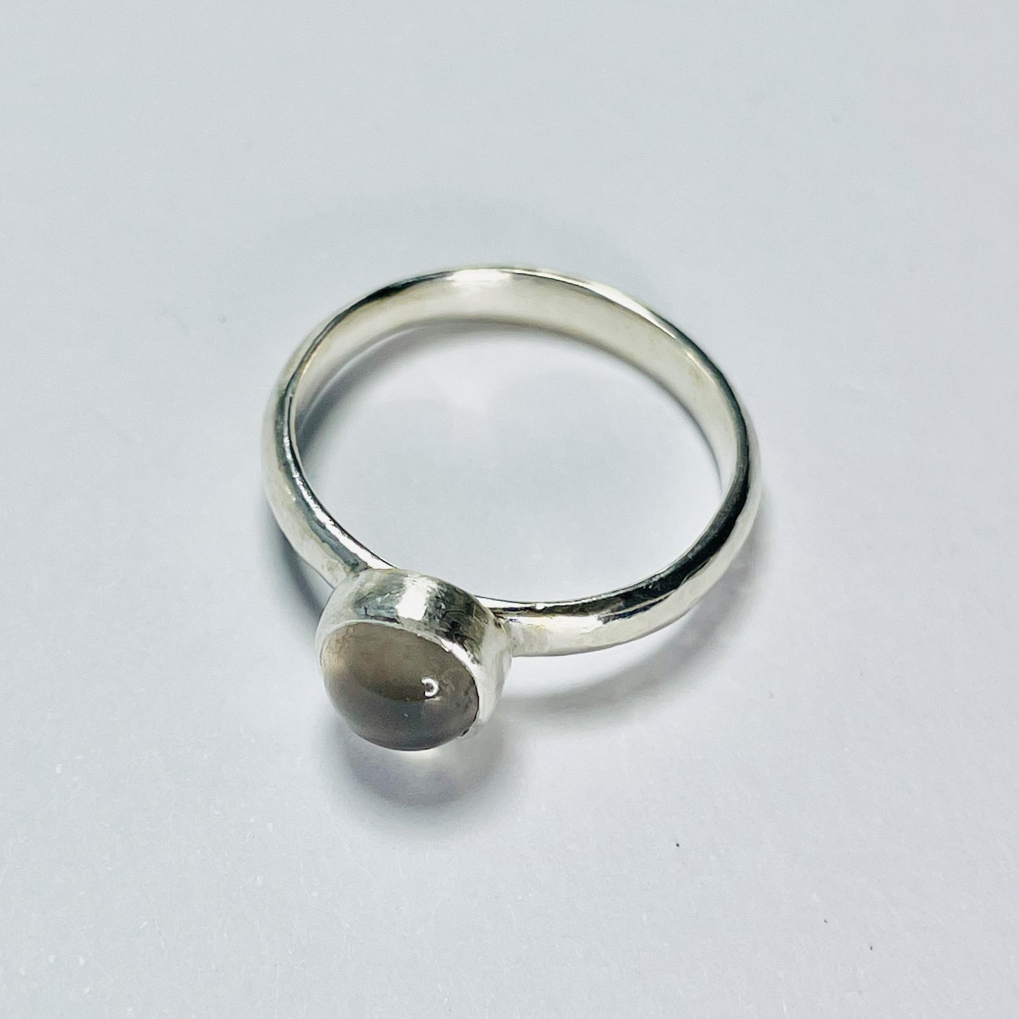 The Expanded Skies Full Moon Moonstone Ring has a tranquil beauty of the light of the full moon reflected on a still pool. Totally handcrafted, it features an ethically mined moonstone from Sri Lanka set in quality 100% recycled sterling silver with a hammered band. 