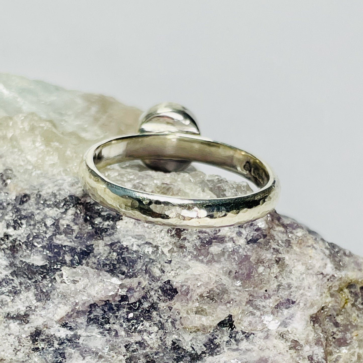 The Expanded Skies Full Moon Moonstone Ring has a tranquil beauty of the light of the full moon reflected on a still pool. Totally handcrafted, it features an ethically mined moonstone from Sri Lanka set in quality 100% recycled sterling silver with a hammered band. 