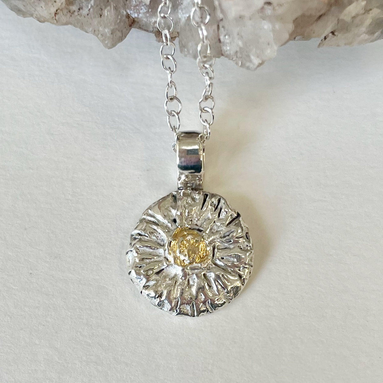 The Expanded Skies Michaelmas Daisy Pendant is totally handcrafted in 100% recycled fine silver (999) with 22ct gold. It has a textured surface that has a twinkly beauty all of its own. 22ct heavy gold foil is applied using keum boo, a traditional Korean gilding technique, that uses heat and pressure, which makes each piece unique. It can be worn every day or for more formal occasions.