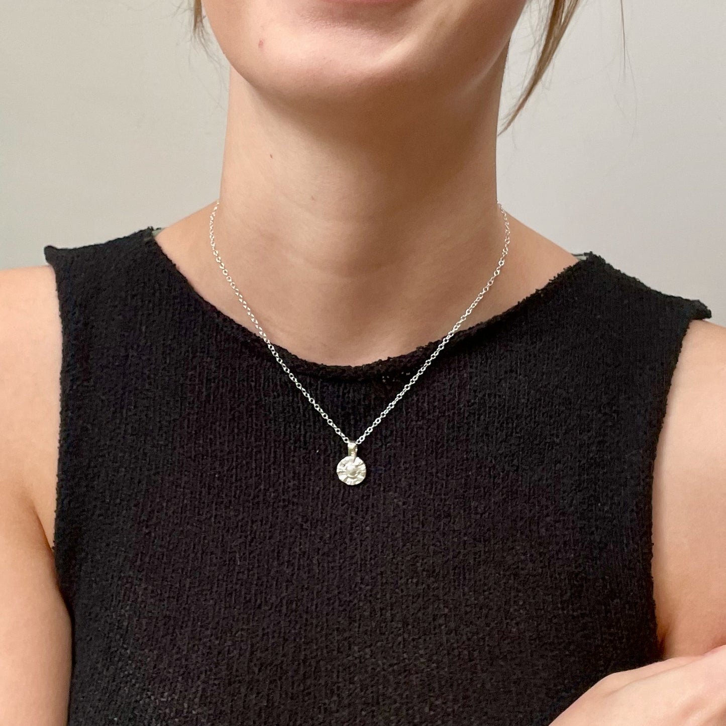 The Radiant Sun Pendant is joyful! Hand sculpted in recycled solid fine silver (999) with a textured surface with a twinkly beauty. It can be worn everyday or as a beautiful detail on more formal occasions.