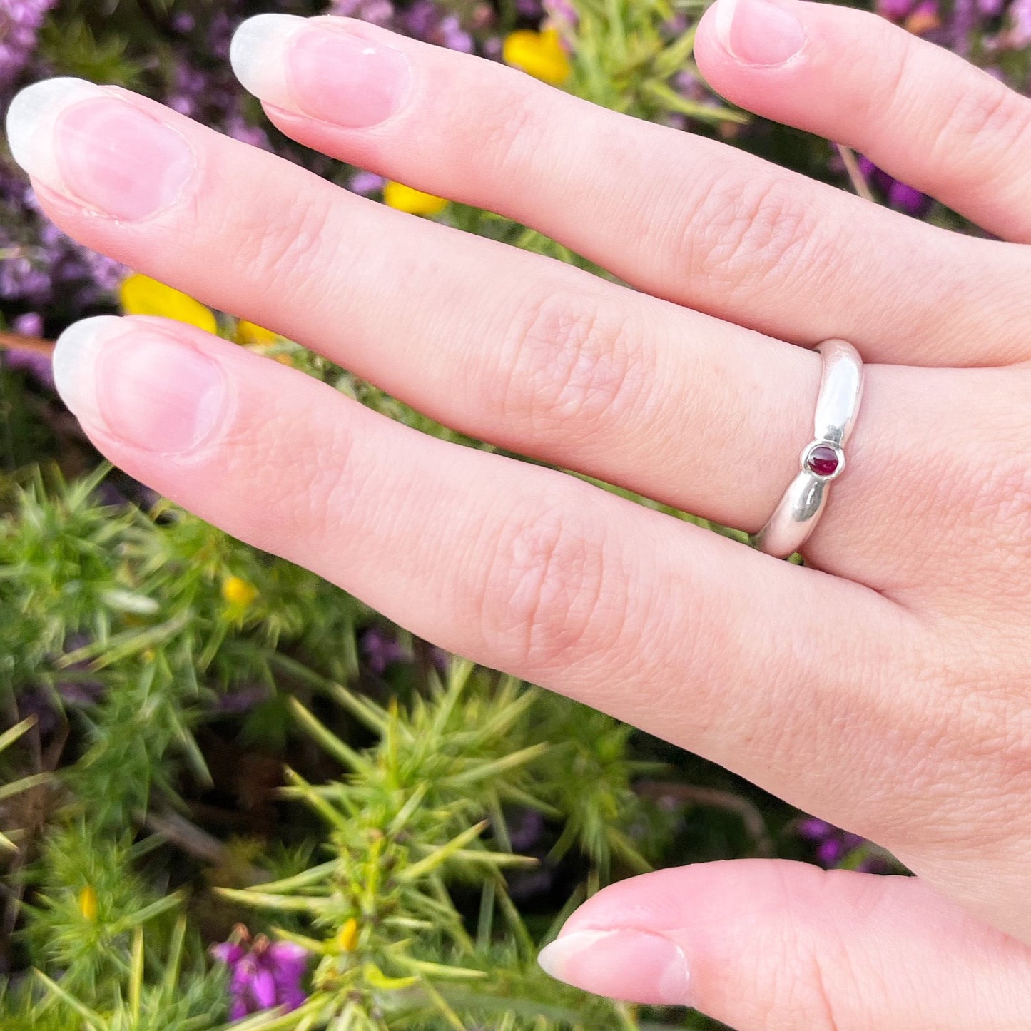 The Ruby-Joy Ring is has a hint of the 1950's exuberance of pinched waists and wide skirts, with a tapering silver band that clasps the oval lustrous pink-red ethically sourced Greenland ruby. With a timeless elegance that can be worn everyday or for special occasions. Dimensions: 2mm D-shaped recycled sterling silver band 4mm x 3mm approx Ethically Mined Greenland Ruby