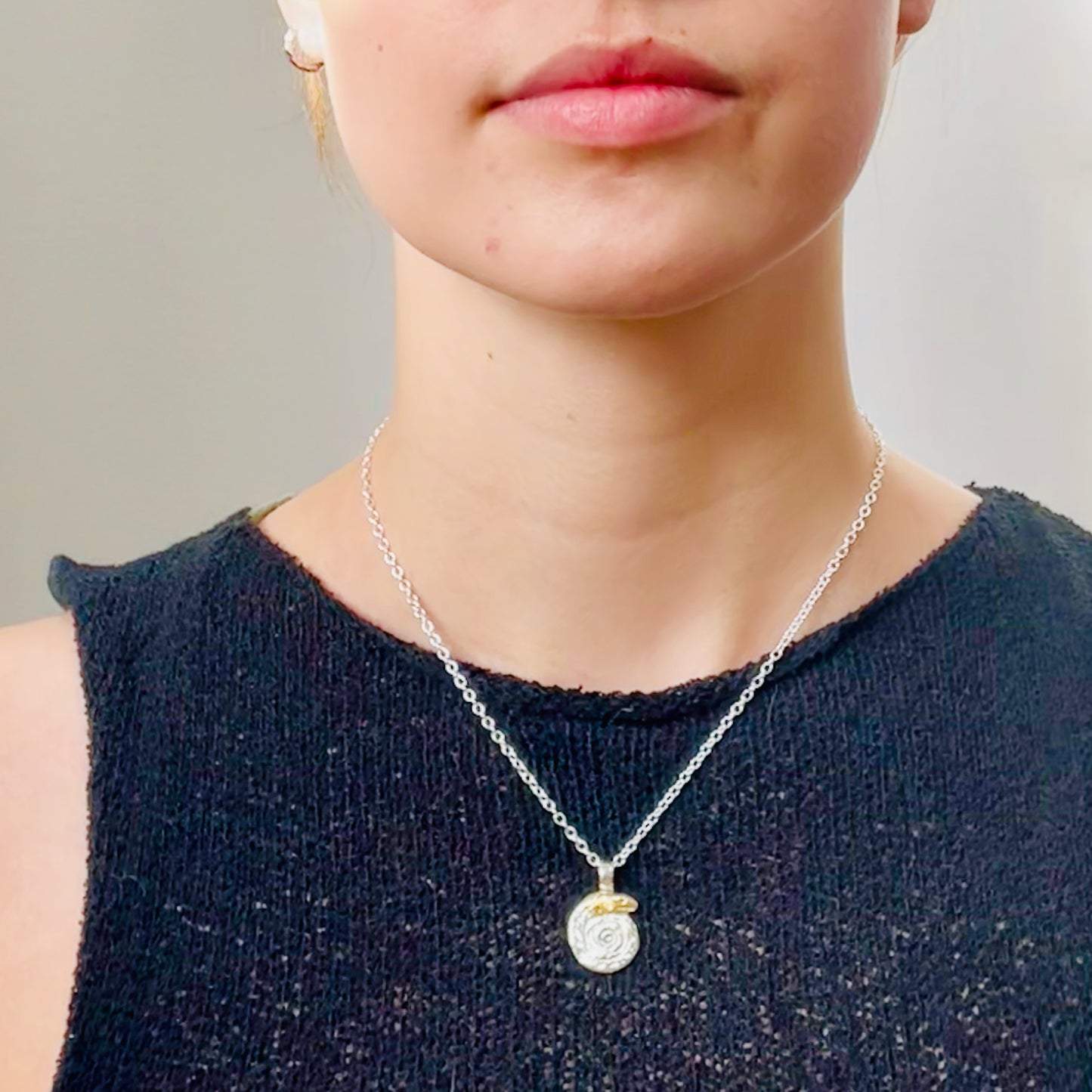 The Expanded Skies Spiral Snake pendant is totally handcrafted in 100% recycled fine silver (999) with 22ct gold. It has a textured surface that has a twinkly beauty all of its own. 22ct heavy gold foil is applied using keum boo, a traditional Korean gilding technique, that uses heat and pressure, which makes each piece unique. It can be worn every day or for more formal occasions