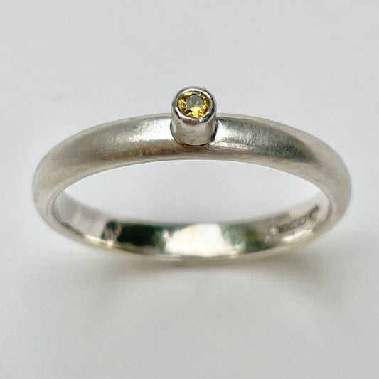 The Sun Beam Yellow Sapphire ring has the clear and simple beauty of golden yellow ethically mined Sri Lankan yellow sapphire set on a matt silver sterling silver band. Understated and beautiful, it can be worn everyday or for special occasions.