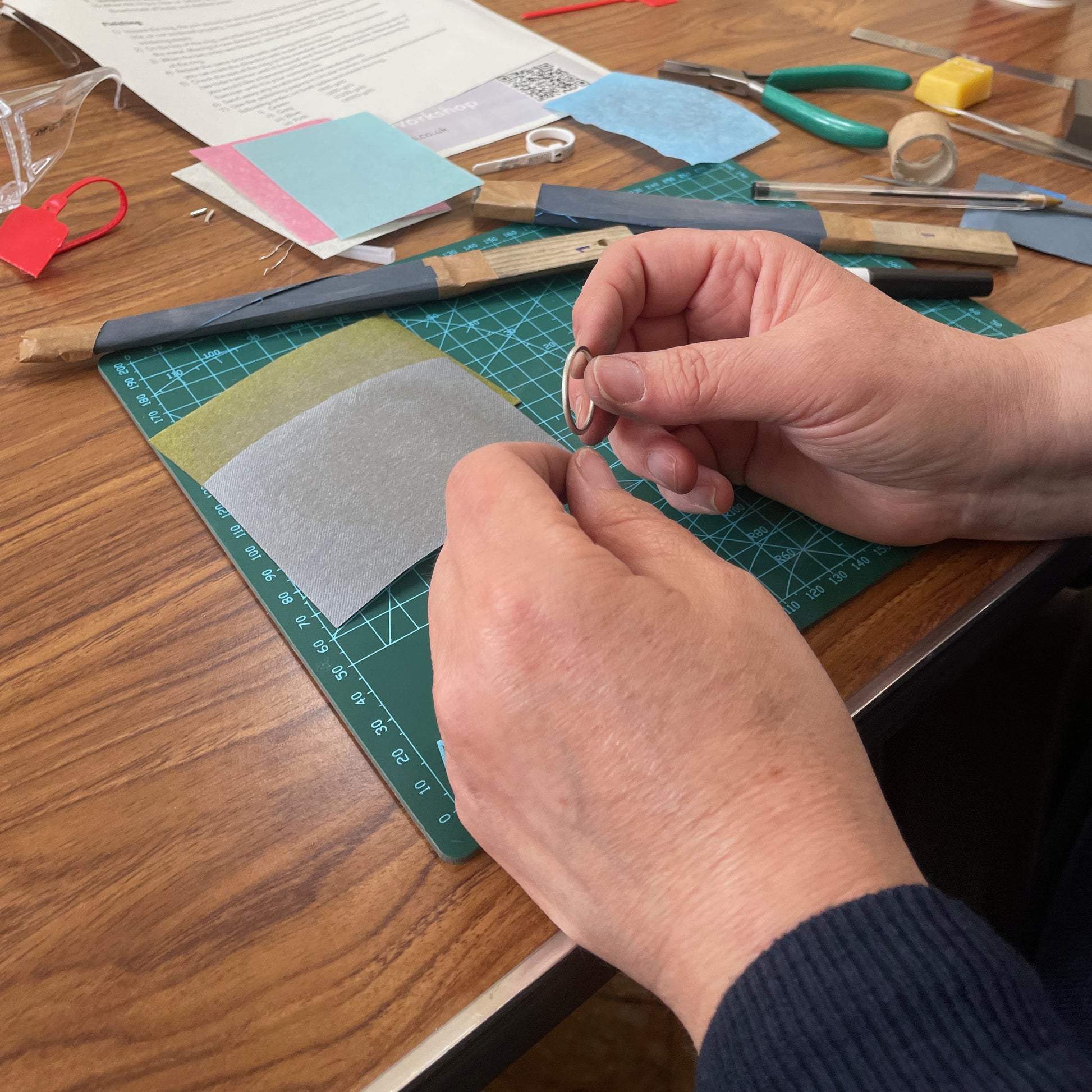 Ashburton Jewellery School Create a silver pendant in this fun workshop on Saturday 12 July 2025. Picture of attendee at the venue, St Lawrence Chapel, Ashburton, Devon, UK.