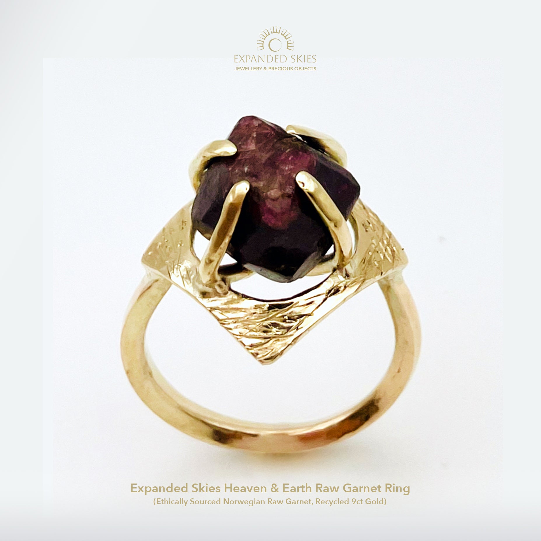 The Expanded Skies Heaven and Earth Raw Garnet Ring has a beautiful raw Norwegian garnet set in 9ct gold. The garnet is set in a distinctive completely handcrafted engraved claw setting. This is a unique piece, one-of-a-kind. Handcrafted on the edge of Dartmoor and made from high quality recycled gold, Hallmarked by the London Assay Office.