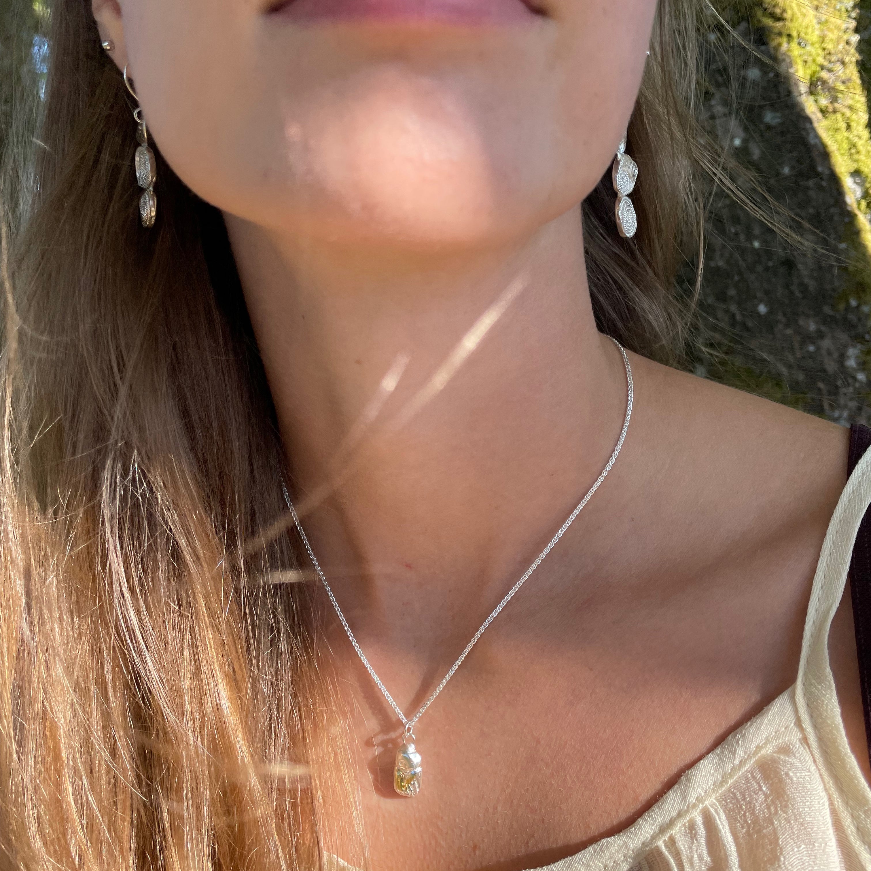 The Expanded Skies Dartmoor Scarab Pendant Necklace is inspired by the Dumbledore or Dor beetle, recycled fine silver with 24ct gold accents, worn on Dartmoor.Ashburton Jewellery School Bespoke workshops for friends, couples, parties and celebrations. 