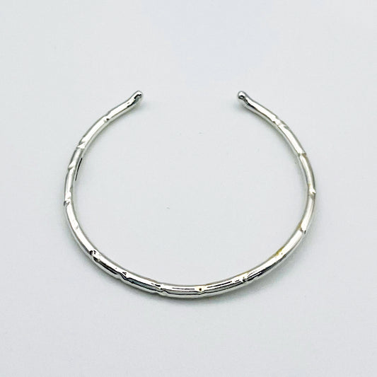 Expanded Skies Dartmoor Torc Bangle combines the classic shape with the textures and hand engraving that evokes the granite landscape. 
The bangle is totally handcrafted on the edge of Dartmoor in the Expanded Skies signature hand-drawn aesthetic. Made from high quality recycled sterling silver. For men and women, simple, beautiful. 
