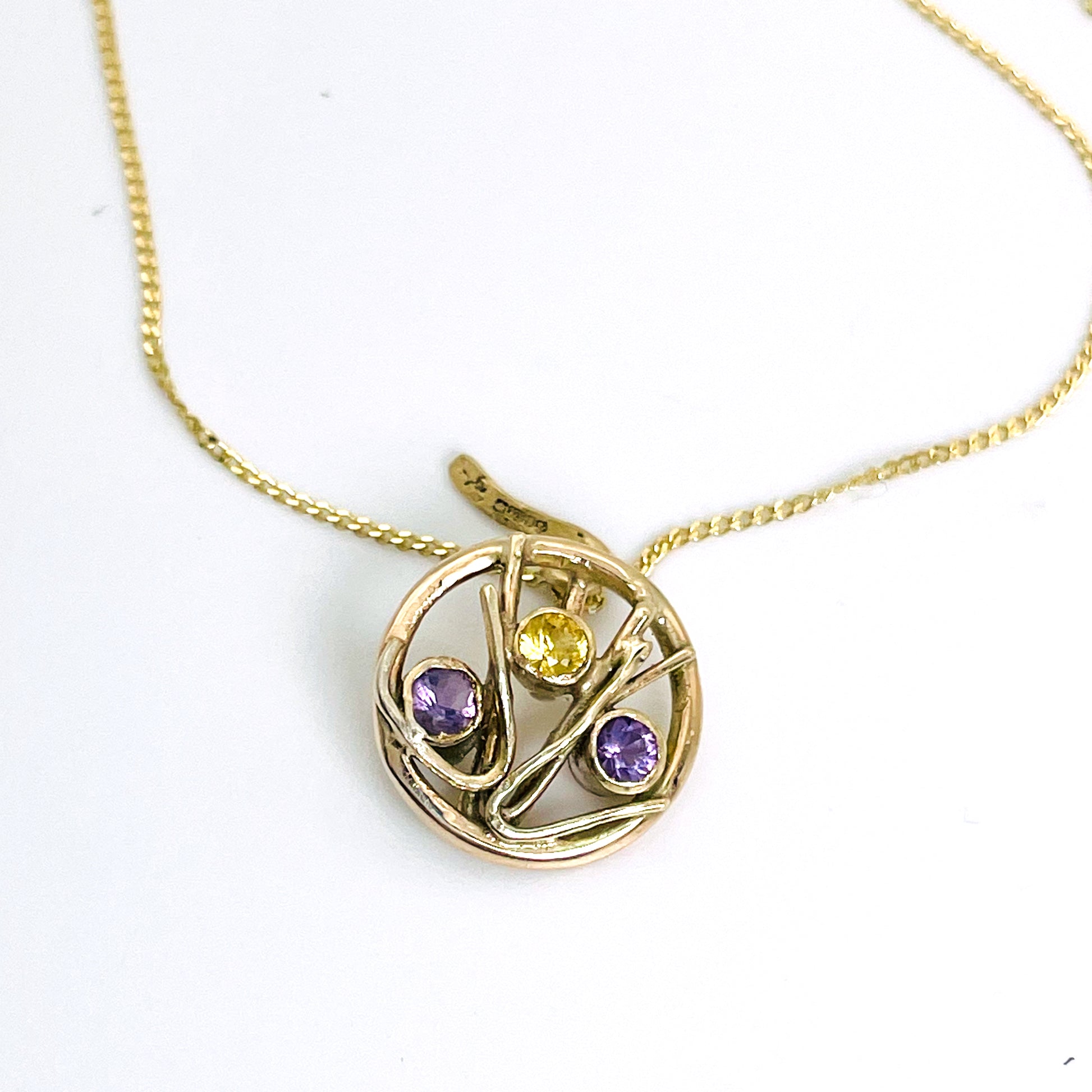 The Expanded Skies Dartmoor Heather and Gorse Pendant evokes the beautiful yellows of the gorse and purples of the heather with an ethically sourced yellow sapphire and two amethysts held in twisting branches of 9ct yellow gold. The pendant comes with a 9ct gold chain, a choice of lengths are available.
This handcrafted unique, one-off, piece makes a wonderful gift, celebrating the evocative and joyful colours of Dartmoor.