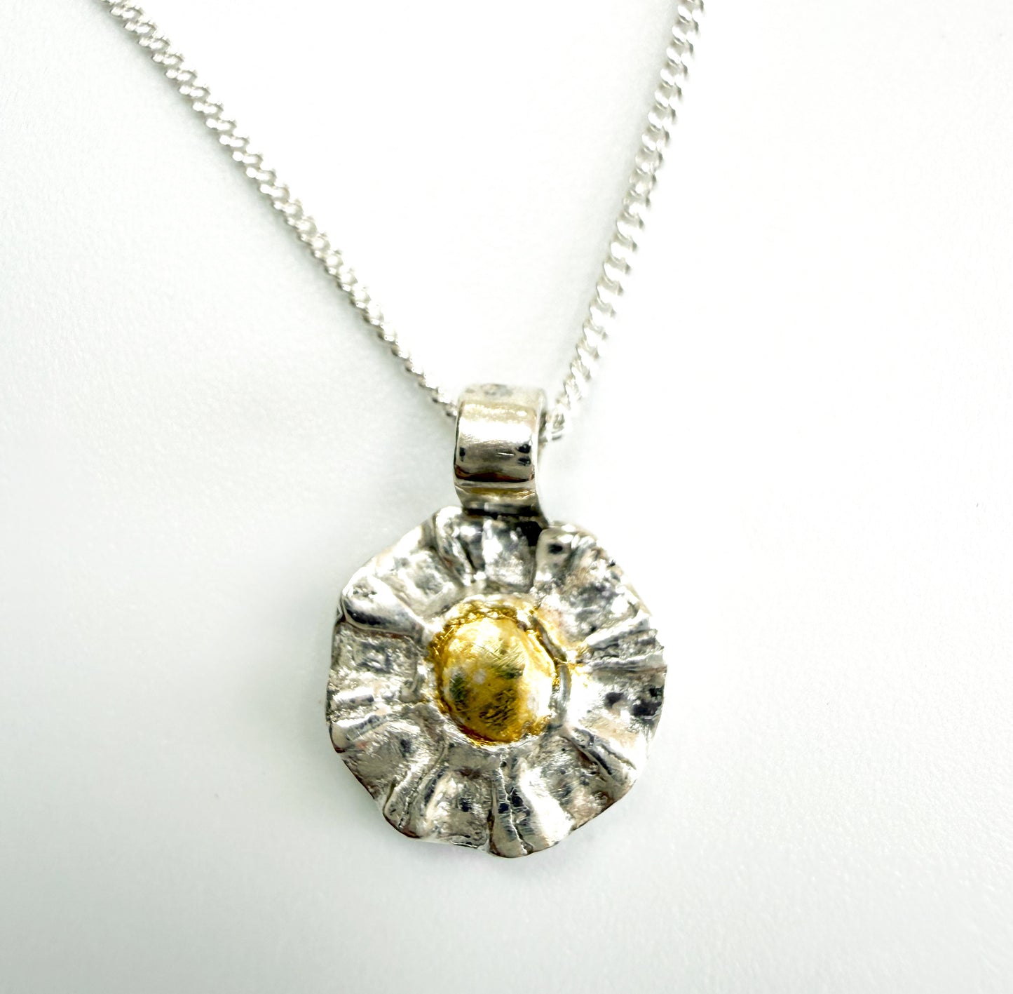 The Expanded Skies Radiant Sun Pendant&nbsp;is joyful! Hand sculpted and cast in recycled solid fine silver (999) with a textured surface that has a twinkly beauty all of its own. Each sun is unique.