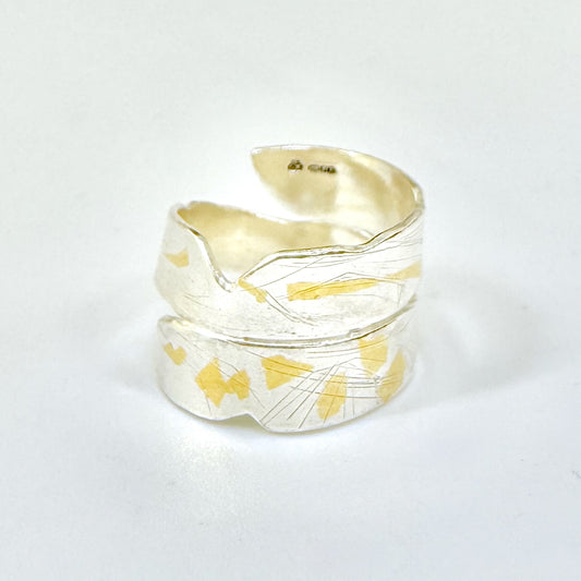 Expanded Skies River Dart Riverbed Ring with 24ct Gold Accents is inspired by the River Dart drawn with hand engraving and gold accents.