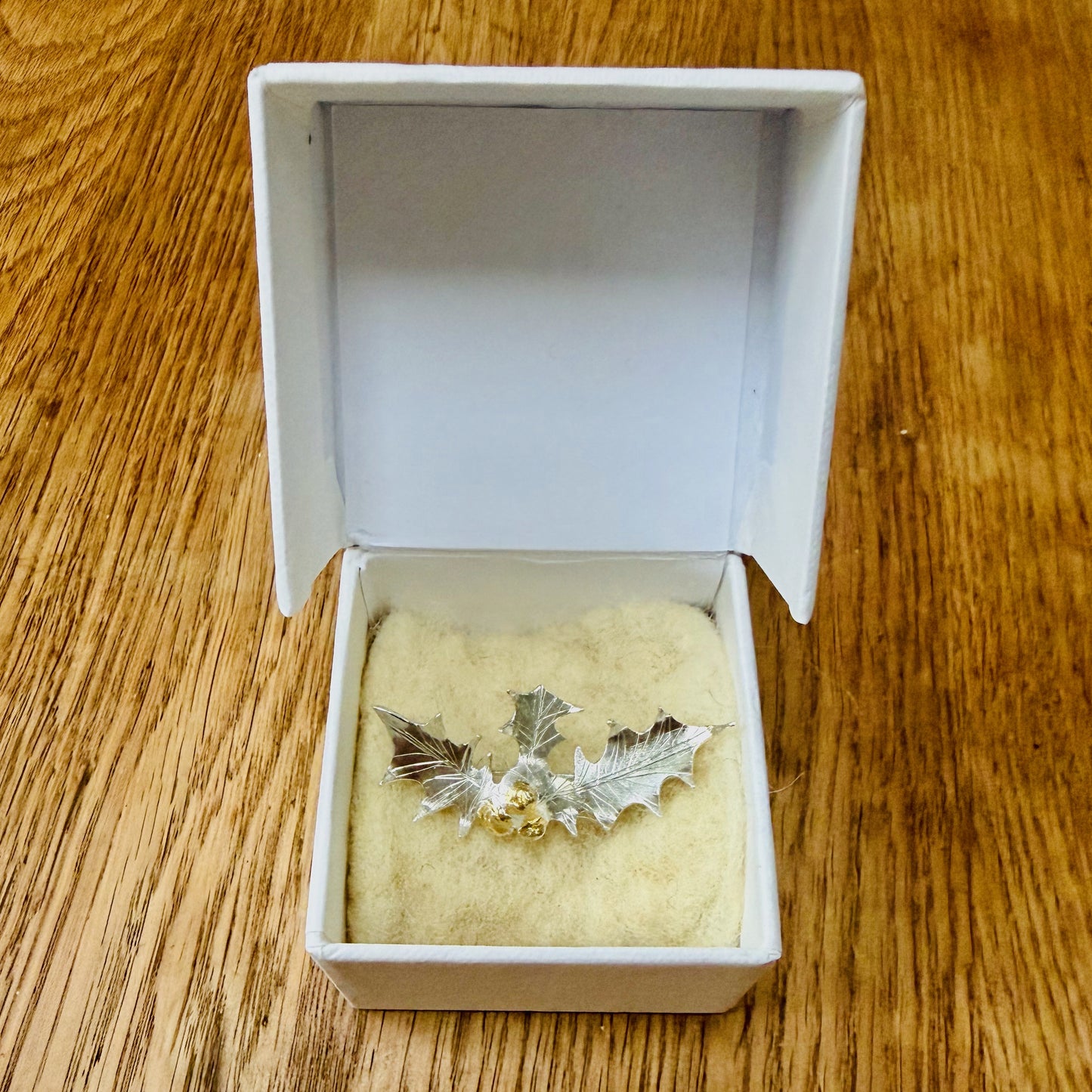 The Expanded Skies Dartmoor Holly Brooch celebrates the sculptural beauty of this native tree.

Totally handcrafted on the edge of Dartmoor and made from recycled fine and sterling silver fused with 24ct gold accents, applied using the Korean gilding process of keum boo.

Each brooch is unique. A simple and elegant addition to any outfit.