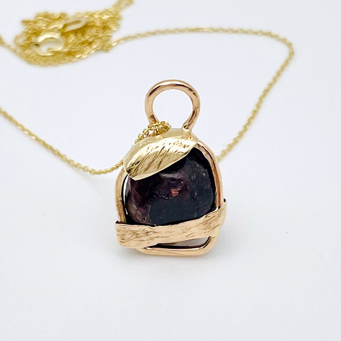 The Expanded Skies Raw Garnet Engraved Pendant has a beautiful raw Norwegian garnet set in 9ct gold. Handcrafted on the edge of Dartmoor and made from high quality recycled gold, Hallmarked by the London Assay Office. The garnet is housed in gold gateway, understated and beautiful, it can be worn every day or for special occasions. This is a unique piece, one-of-a-kind.