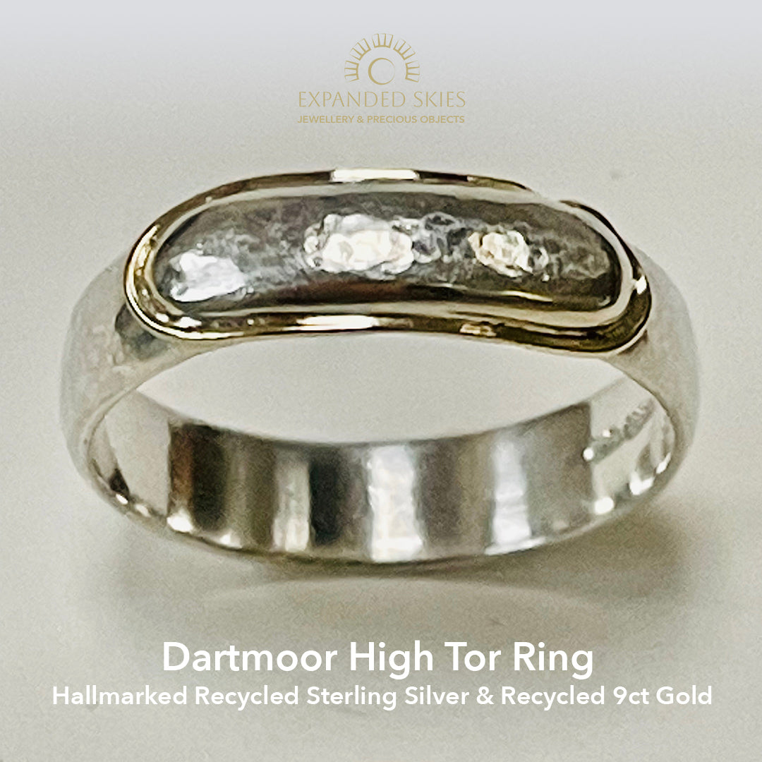 The Dartmoor High Tor Hammered Ring inlaid with 9ct Gold is inspired by the rugged beauty of the granite moorland. The band is handcrafted from sold sterling recycled silver. The 'tor' (referring to the mounded rocks on the summit of hills on Dartmoor) is layered with a sterling silver 'tor', inlaid with recycled 9ct Gold.