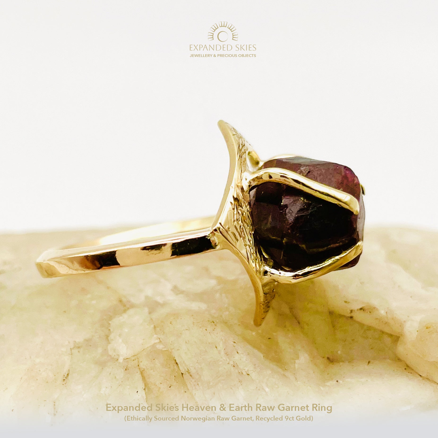 The Expanded Skies Heaven and Earth Raw Garnet Ring has a beautiful raw Norwegian garnet set in 9ct gold. The garnet is set in a distinctive completely handcrafted engraved claw setting. This is a unique piece, one-of-a-kind. Handcrafted on the edge of Dartmoor and made from high quality recycled gold, Hallmarked by the London Assay Office.