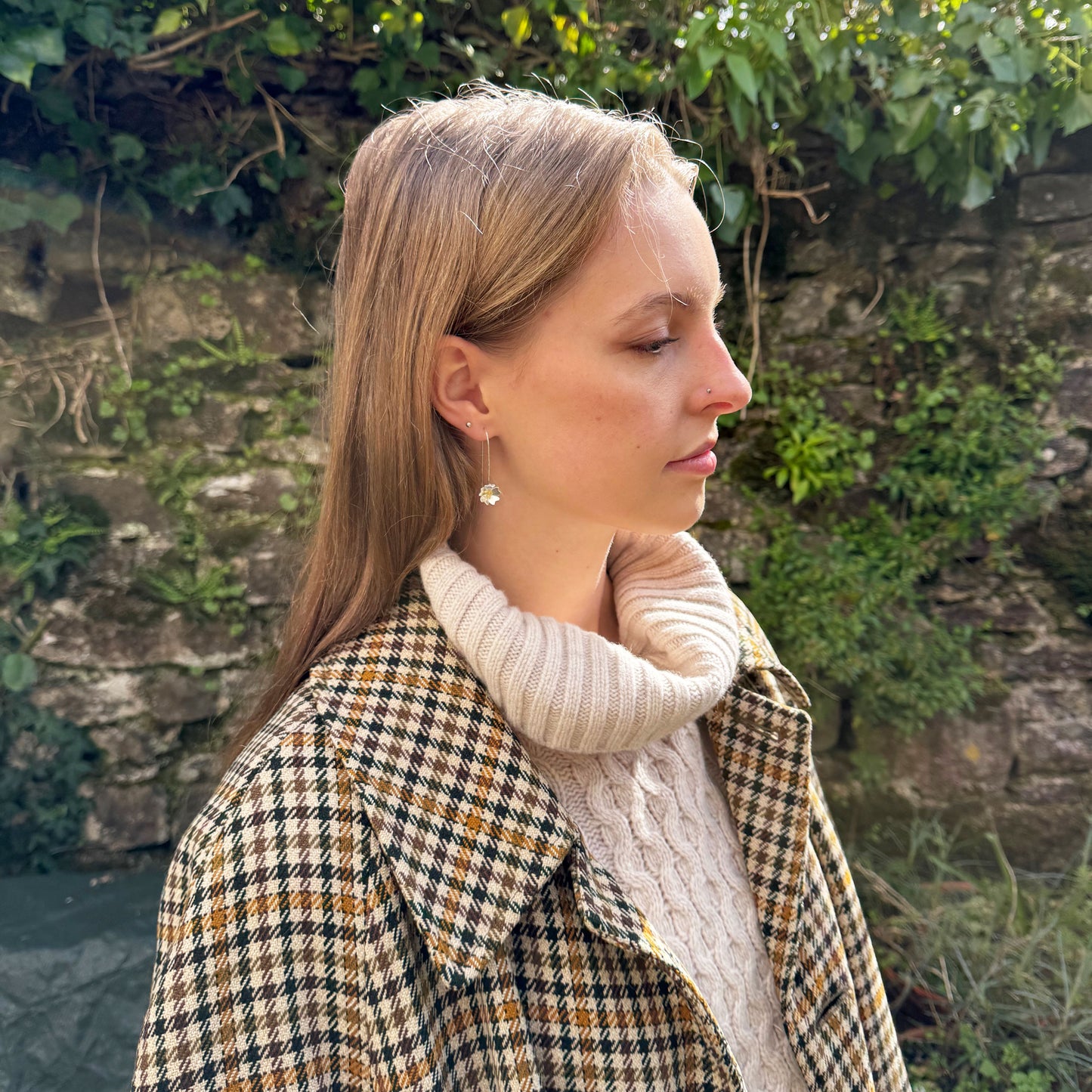 The Expanded Skies Dartmoor Field Rose Drop Earrings capture the joyous simple beauty of the field rose, Rosa arvensis, that is seen weaving brightly through the Dartmoor hedgerows and woodland. Hand pierced and formed in recycled fine silver with recycled 24ct gold accents and recycled sterling silver ear wires. Worn on model