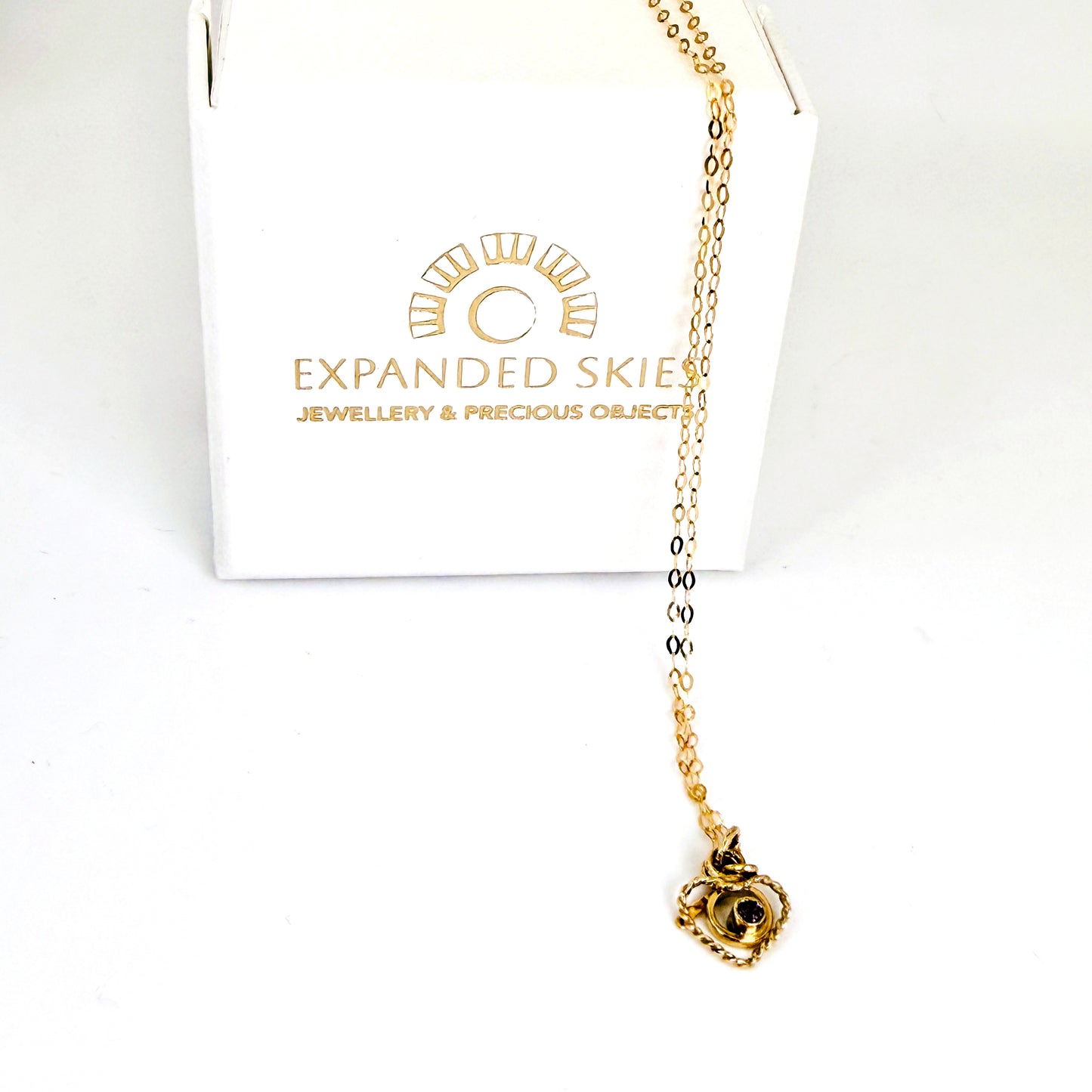 The Expanded Skies Joyful Heart Amethyst Filigree Necklace Pendant has a beautiful ethically sourced faceted amethyst set in 9ct gold bezel on a 9ct filigree gold heart. Totally handcrafted on the edge of Dartmoor and made from high quality recycled gold. Understated and beautiful, it can be worn every day or for special occasions. With Expanded Skies box handcrafted in Cornwall.