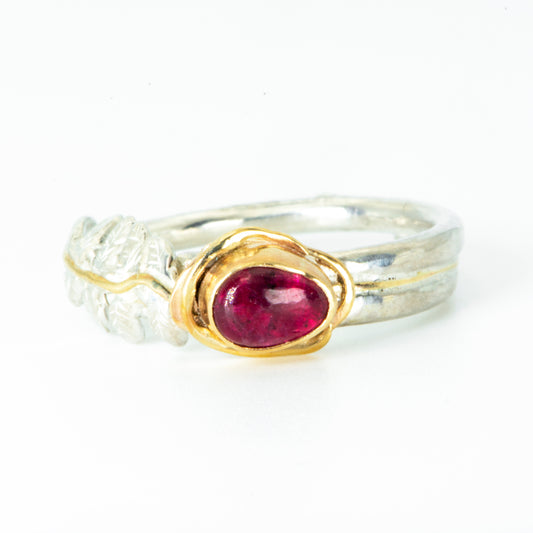 xpanded Skies Dartmoor Rowan Leaf and Berries Spinel Ring. The Expanded Skies Dartmoor Rowan Leaf and Berries Spinel Ring is totally handcrafted on the edge of Dartmoor. The ring is created in recycled sterling silver, inlaid with 9ct gold. The ring is set with an ethically sourced The red-pink spinel, set in 9ct gold, with a hand formed rowan leaf, inlaid with 9ct gold. The ethically sourced 6.5mm pear-shaped spinel is from Moyo Gems run by female miners Tanzanian Women Miners' Association. 