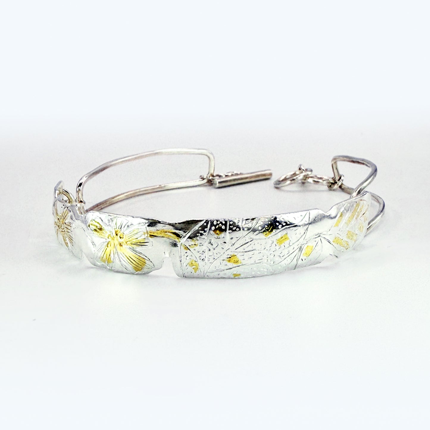 The Expanded Skies Dartmoor Purslane, Hand Engraved Bracelet, celebrates the beauty of the edible Dartmoor flower the Pink Purslane (Claytonia sibirica), created in fine and sterling silver with 24ct gold accents.