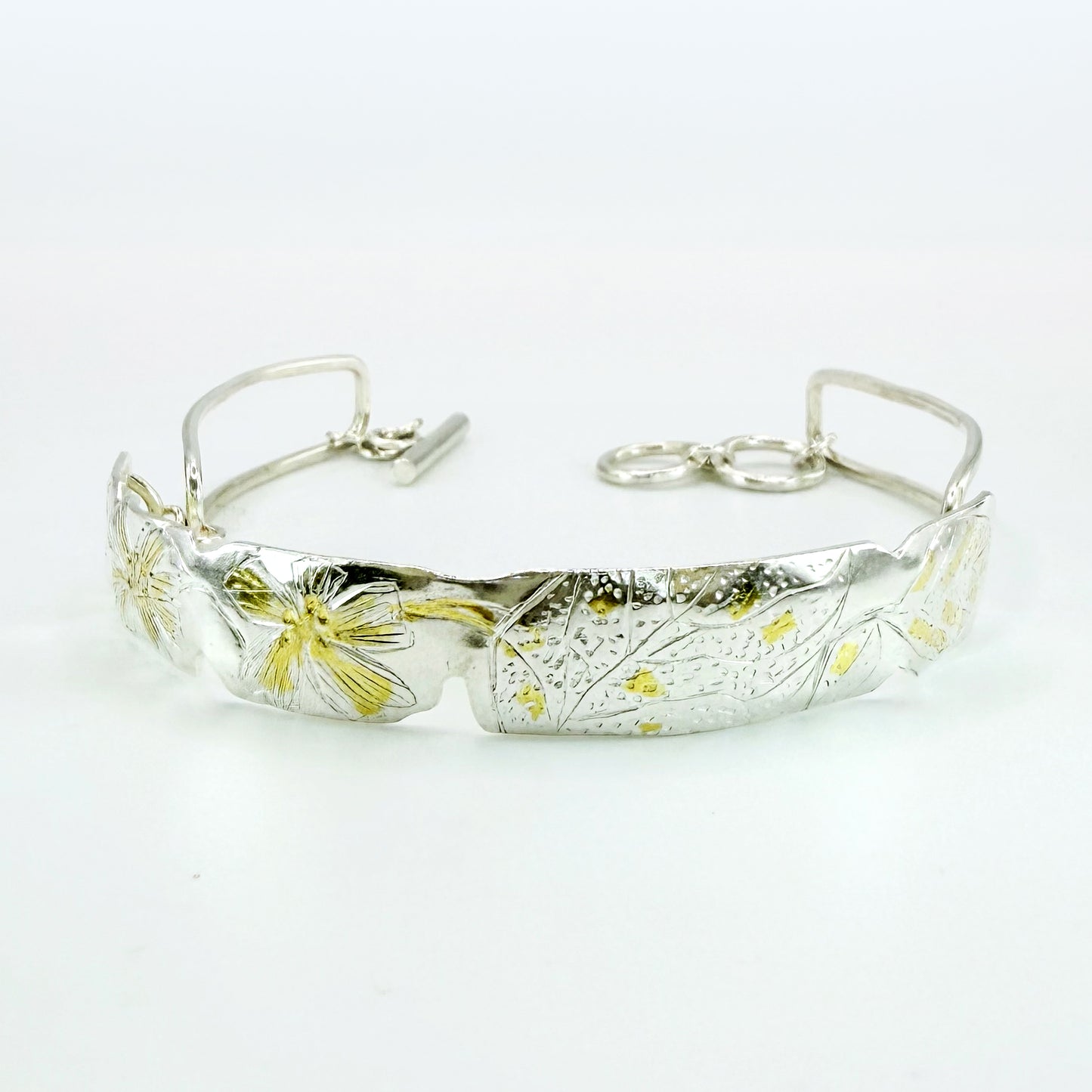 The Expanded Skies Dartmoor Purslane, Hand Engraved Bracelet, celebrates the beauty of the edible Dartmoor flower the Pink Purslane (Claytonia sibirica), created in fine and sterling silver with 24ct gold accents.