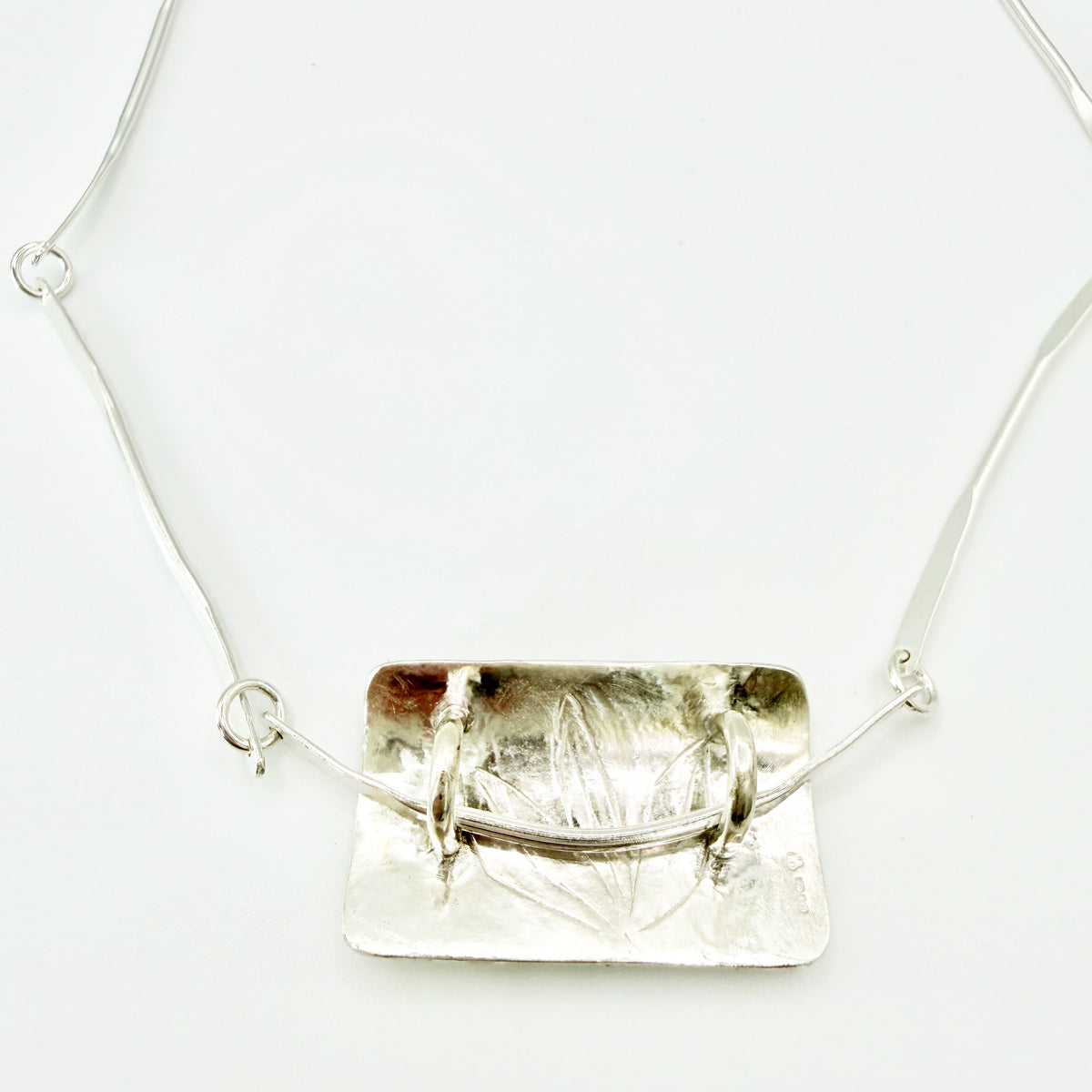 The Expanded Skies Dartmoor Wild Honeysuckle Leaves Necklace is a hand engraved of the graceful honeysuckle (Lonicera periclymenum) as it winds through the trees and brambles in Ausewell Woods. Handcrafted in fine silver with 24ct gold accents, with a completely handcrafted stem and tendril chain in sterling silver. Simple and elegant with a polished finish, it can be worn everyday for any occasion.