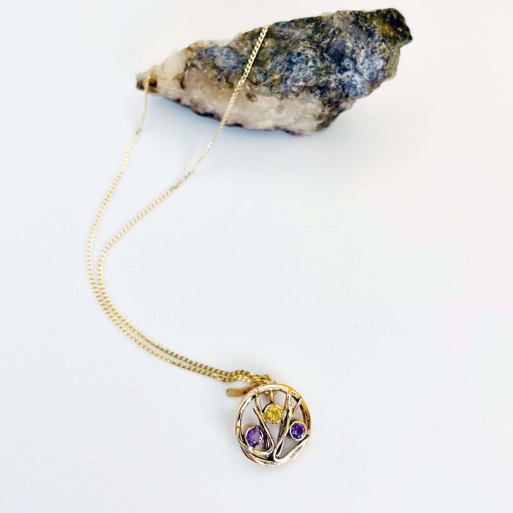 The Expanded Skies Dartmoor Heather and Gorse Pendant evokes the beautiful yellows of the gorse and purples of the heather with an ethically sourced yellow sapphire and two amethysts held in twisting branches of 9ct yellow gold. The pendant comes with a 9ct gold chain, a choice of lengths are available.
This handcrafted unique, one-off, piece makes a wonderful gift, celebrating the evocative and joyful colours of Dartmoor.
