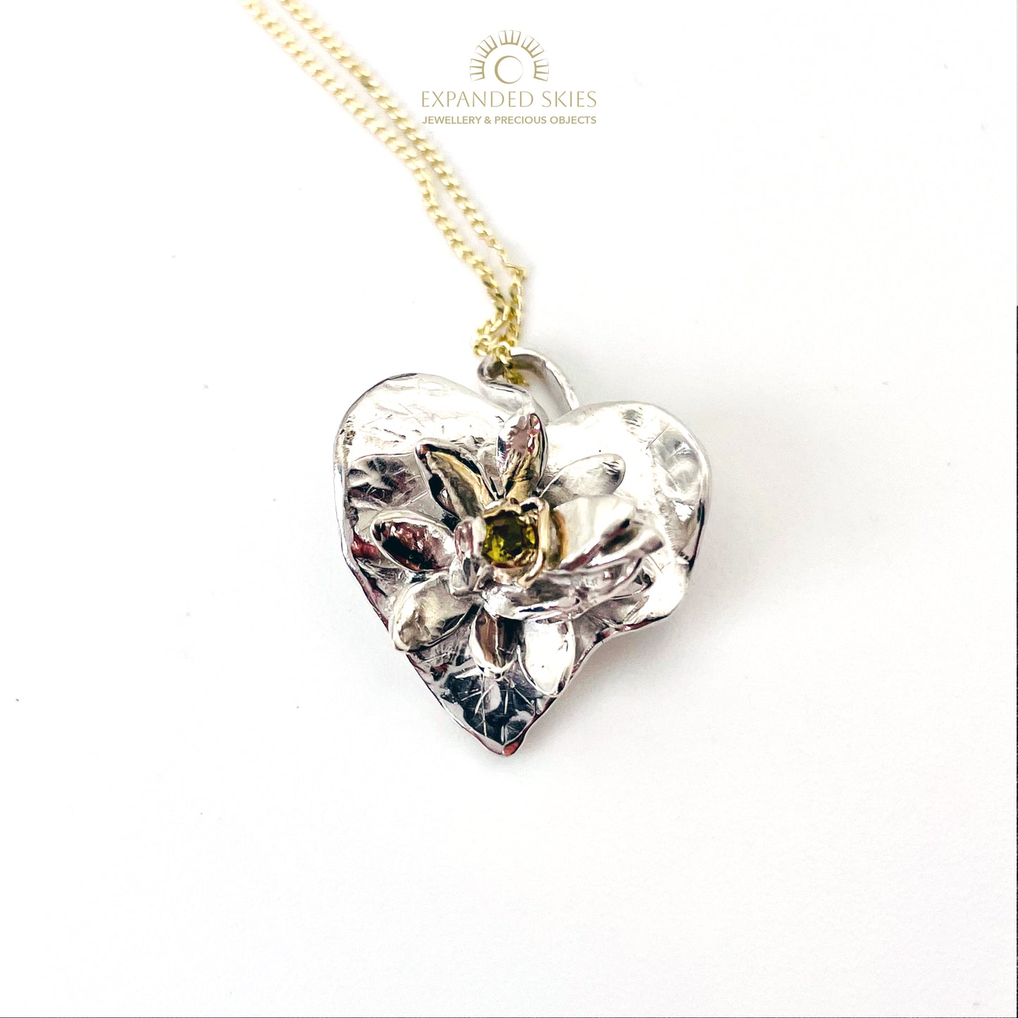 Expanded Skies Celandine Sapphire Pendant, inspired by the profusion of celandine petals found in the meadow near Cuddyford and all along the Dartmoor byways, pure joy! With a 9ct gold diamond cut curb chain pictured.