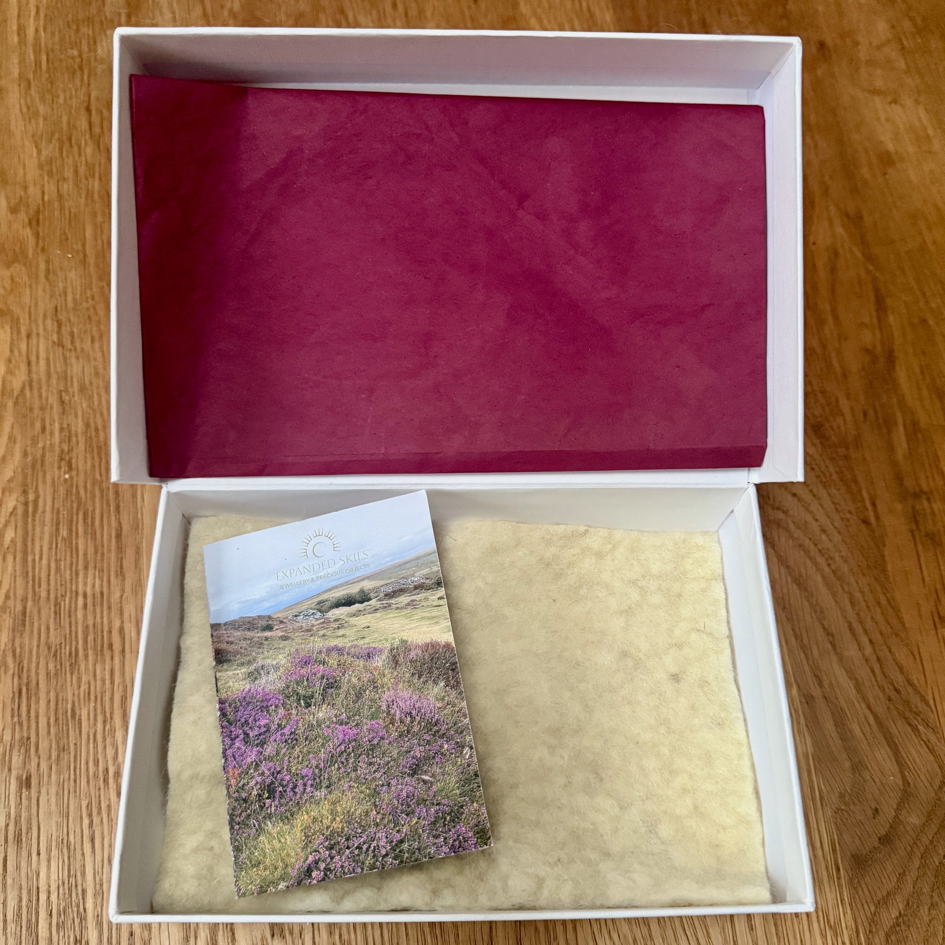 Expanded Skies jewellery comes in a beautiful presentation box, handcrafted in Cornwall made with recycled board and FSC certified textured paper. The boxes are embossed with compostable fine foil. The interior of the box is lined with natural felt made of wool from organically reared sheep by Fern Hill Farm in Somerset. The box has a layer of berry tissue paper made from recycled fibres. The box comes with a card featuring a photograph of Dartmoor printed on FSC certified recycled paper.