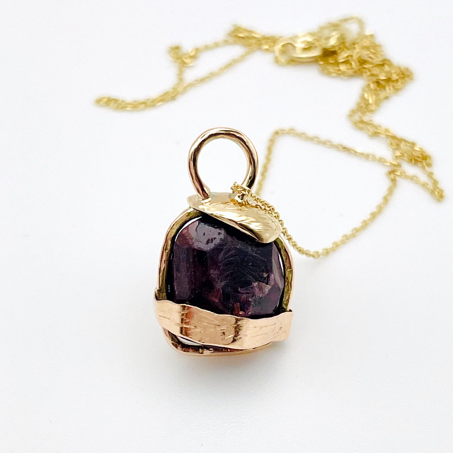 The Expanded Skies Raw Garnet Engraved Pendant has a beautiful raw Norwegian garnet set in 9ct gold. Handcrafted on the edge of Dartmoor and made from high quality recycled gold, Hallmarked by the London Assay Office. The garnet is housed in gold gateway, understated and beautiful, it can be worn every day or for special occasions. This is a unique piece, one-of-a-kind.