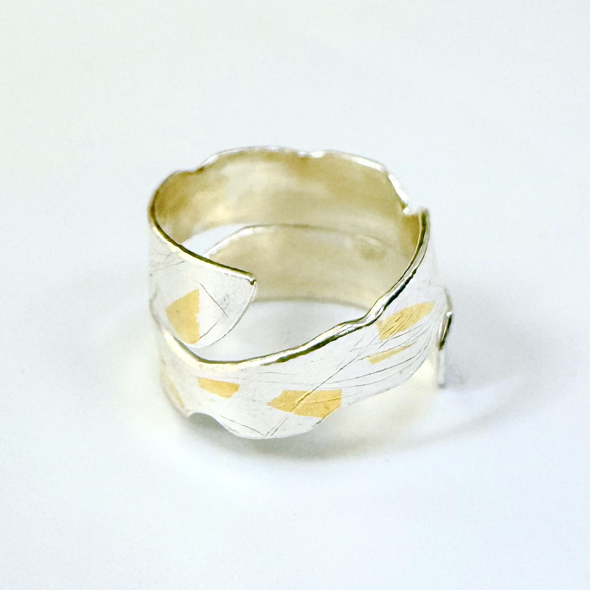 Expanded Skies River Dart Riverbed Ring with 24ct Gold Accents is inspired by the River Dart drawn with hand engraving and gold accents.