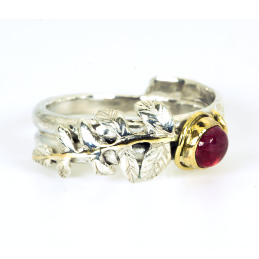
Expanded Skies Dartmoor Rowan Leaf and Berries Spinel Ring. The Expanded Skies Dartmoor Rowan Leaf and Berries Spinel Ring is totally handcrafted on the edge of Dartmoor. The ring is created in recycled sterling silver, inlaid with 9ct gold. The ring is set with an ethically sourced Tanzanian red-pink spinel, set in 9ct gold, with a hand formed rowan leaf, inlaid with 9ct gold. The ethically sourced 4.5mm round spinel is from Moyo Gems. Moyo gems is run by female miners Tanzanian Women Miners' Association.