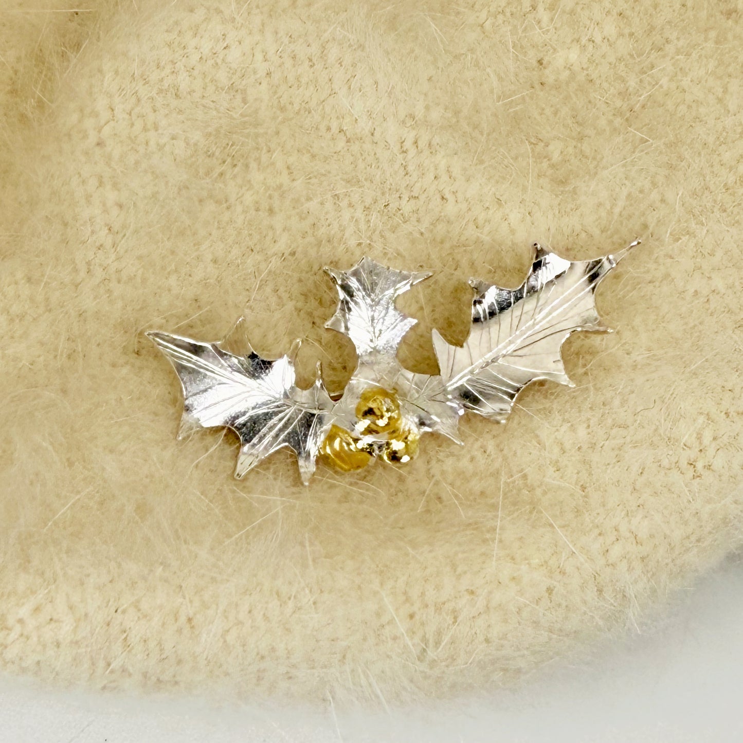 The Expanded Skies Dartmoor Holly Brooch celebrates the sculptural beauty of this native tree.

Totally handcrafted on the edge of Dartmoor and made from recycled fine and sterling silver fused with 24ct gold accents, applied using the Korean gilding process of keum boo.

Each brooch is unique. A simple and elegant addition to any outfit.