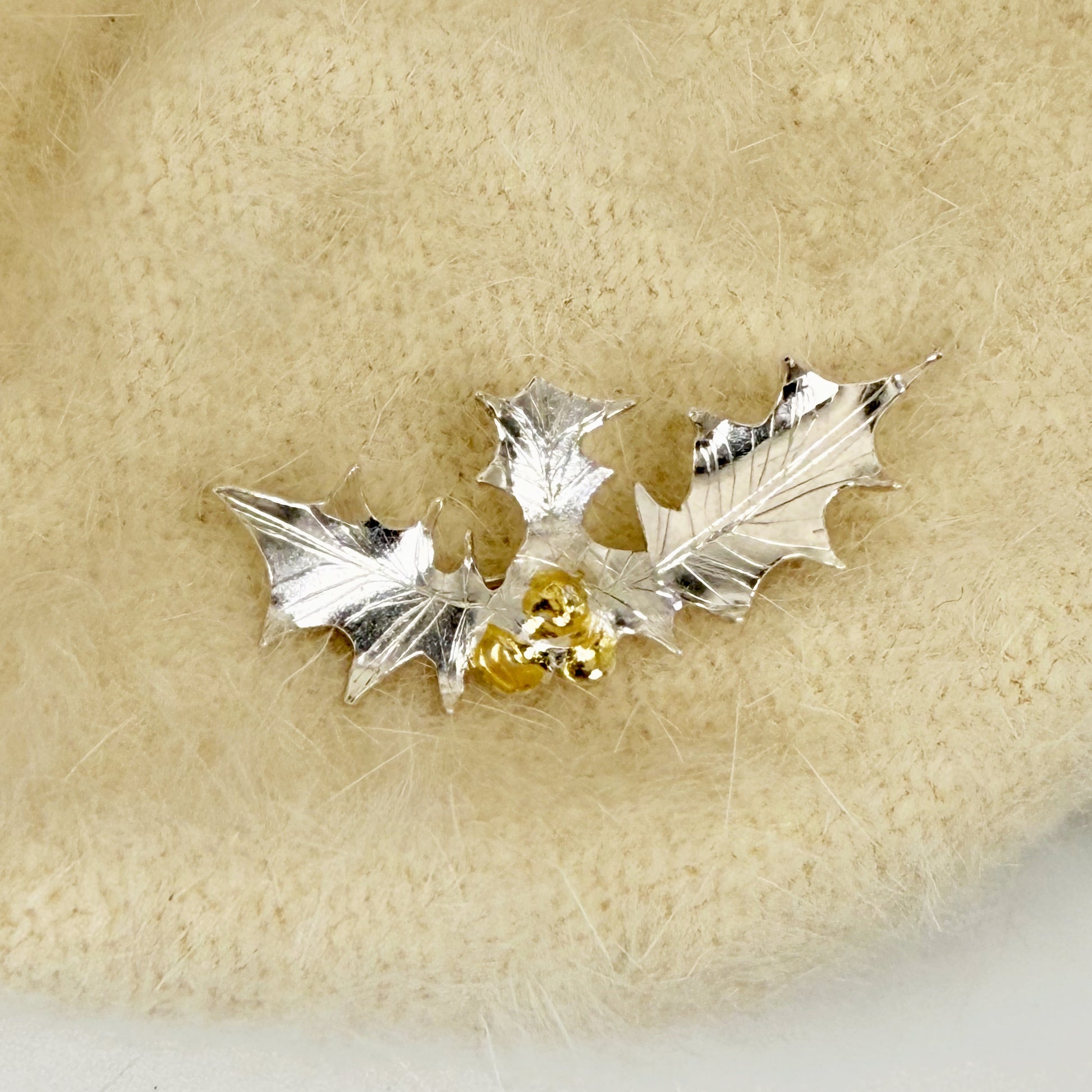 The Expanded Skies Dartmoor Holly Brooch celebrates the sculptural beauty of this native tree.

Totally handcrafted on the edge of Dartmoor and made from recycled fine and sterling silver fused with 24ct gold accents, applied using the Korean gilding process of keum boo.

Each brooch is unique. A simple and elegant addition to any outfit.
